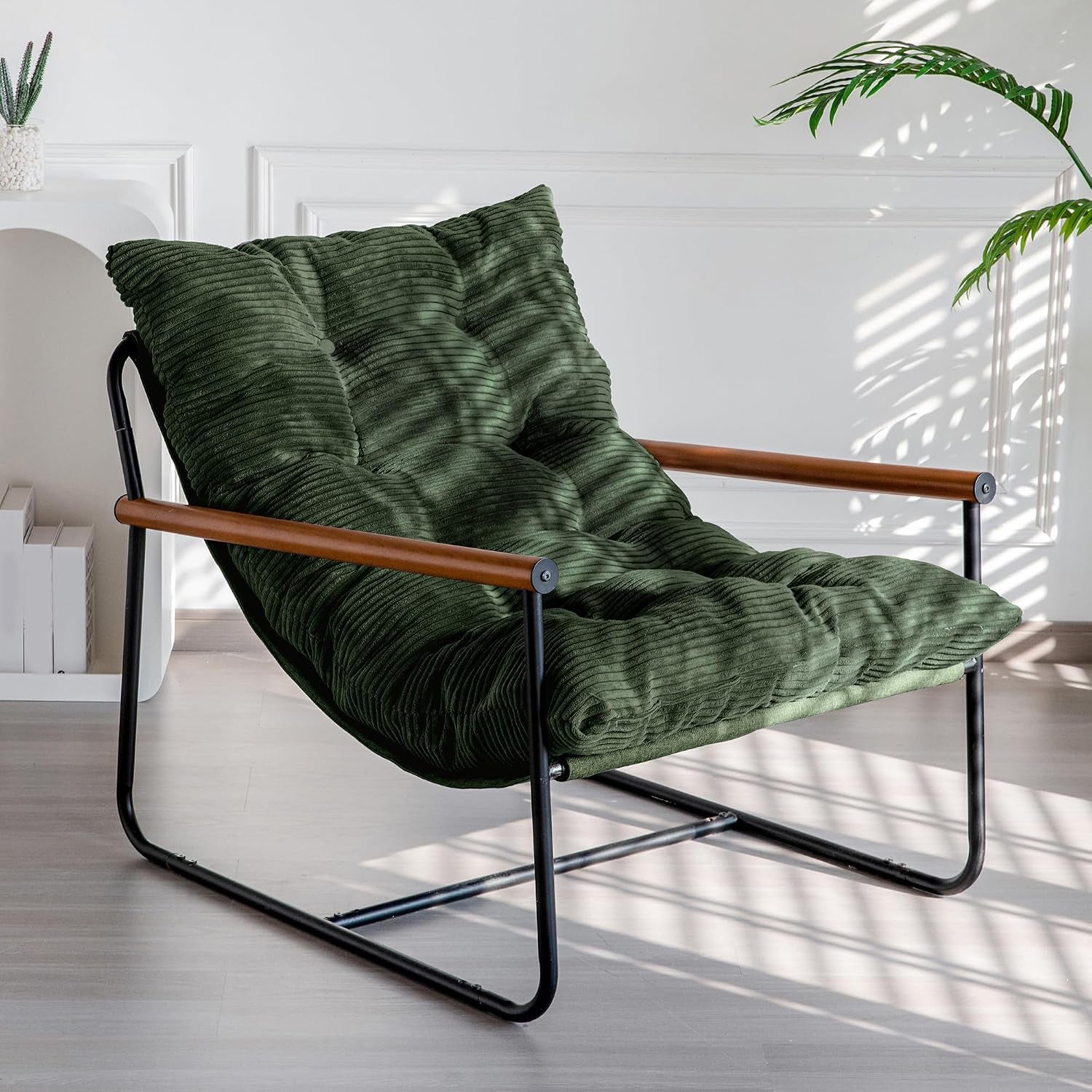 Dark green corded-fabric accent chair angled front view showing metal frame and wooden armrests