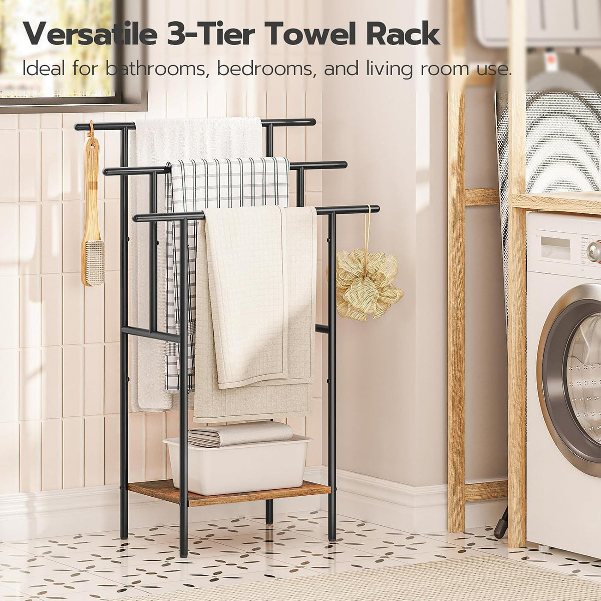 Black frame towel rack with wood-tone lower shelf shown in a laundry-room scene with folded towels and a basket.
