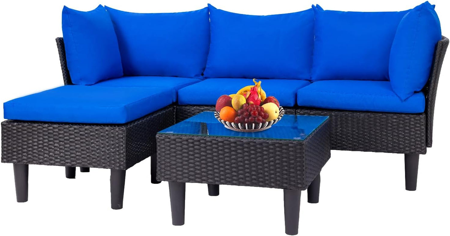 Corner rattan sectional with bright blue back and seat cushions and a square glass-top coffee table