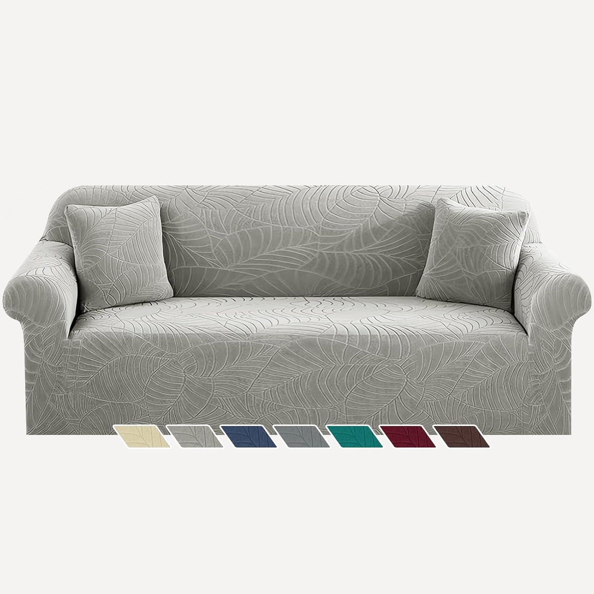 Front view of a three-seat sofa covered in light gray jacquard slipcover with matching throw pillows.