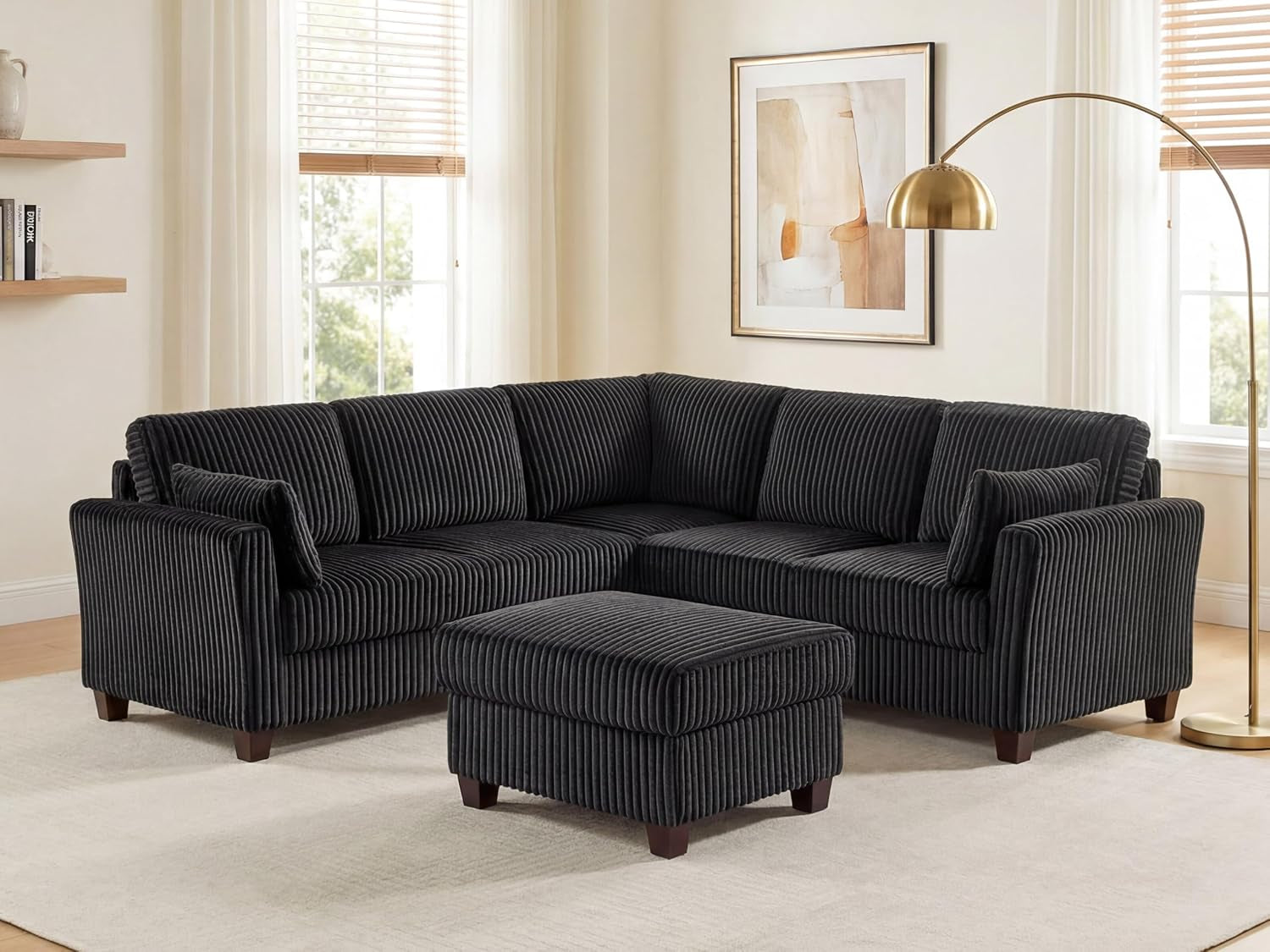Charcoal corduroy L-shaped sectional with matching rectangular ottoman in a bright living room.