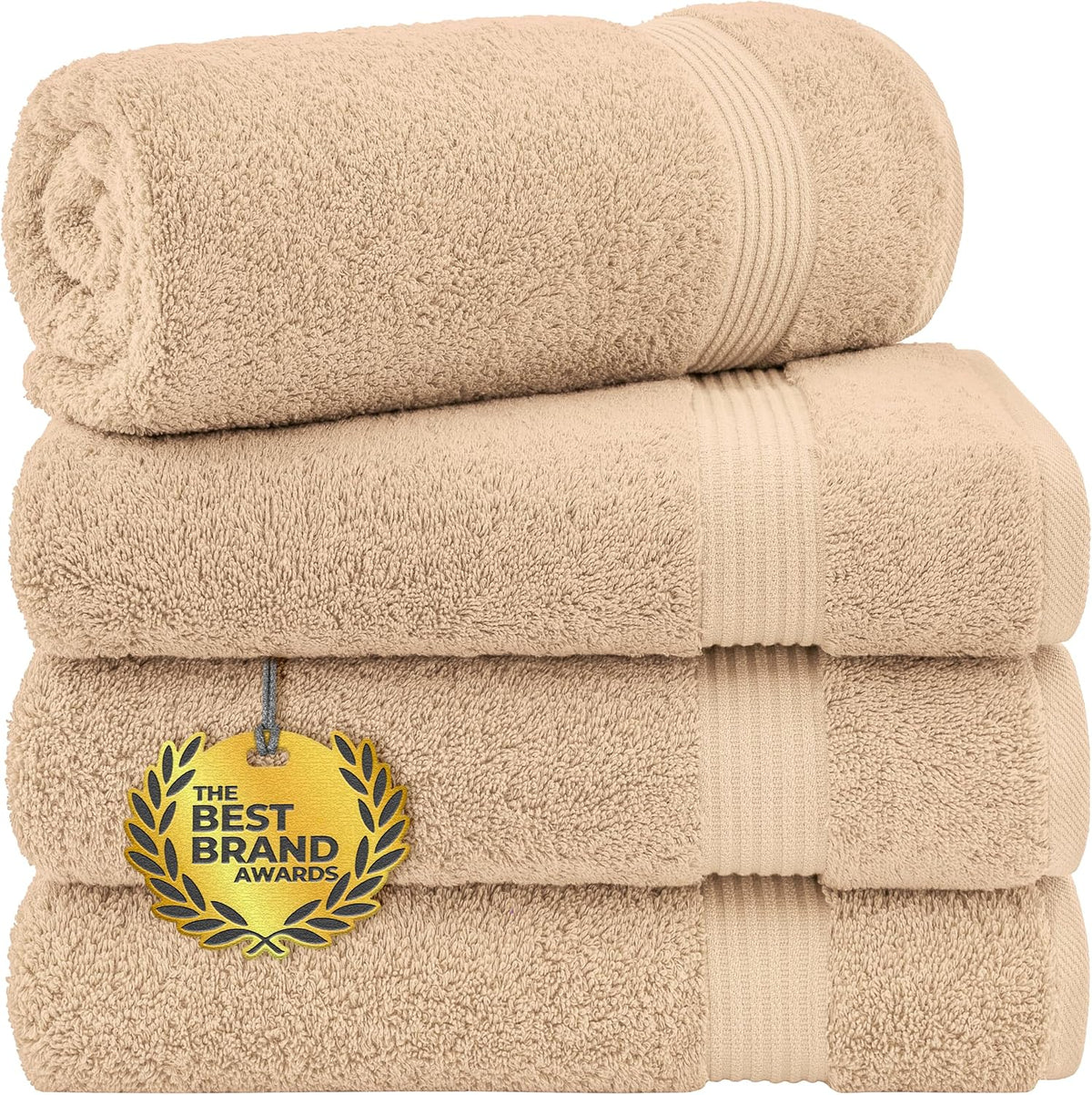 Stack of four rolled and folded beige towels showing plush pile and ribbed bands.