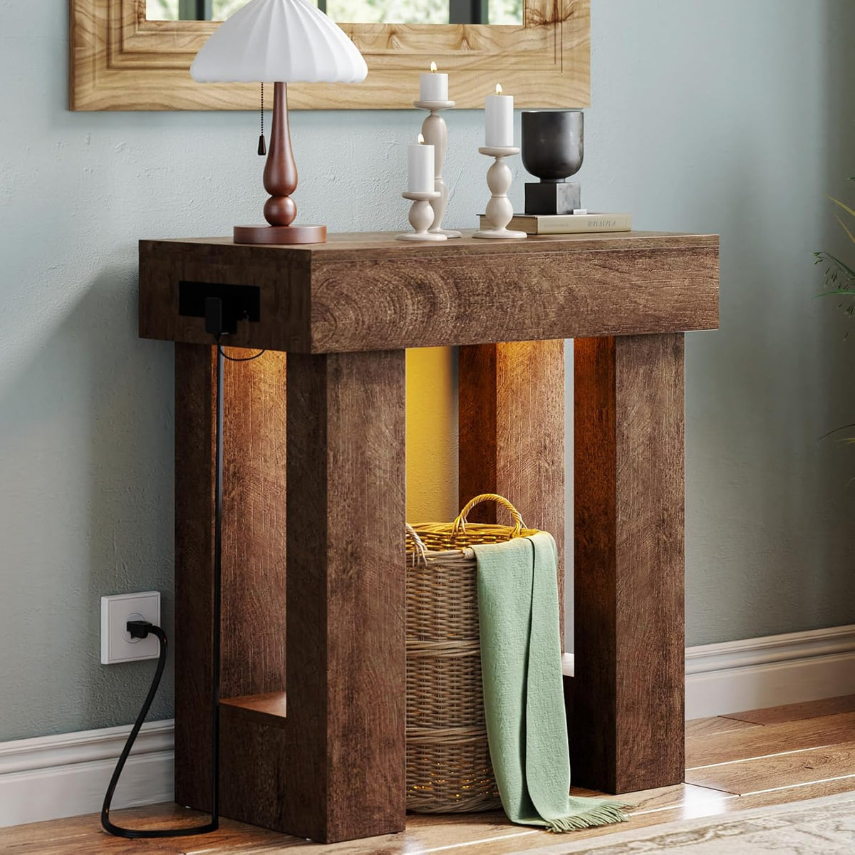 Side profile of the console in a dark brown finish with a lamp and stacked candles on top.
