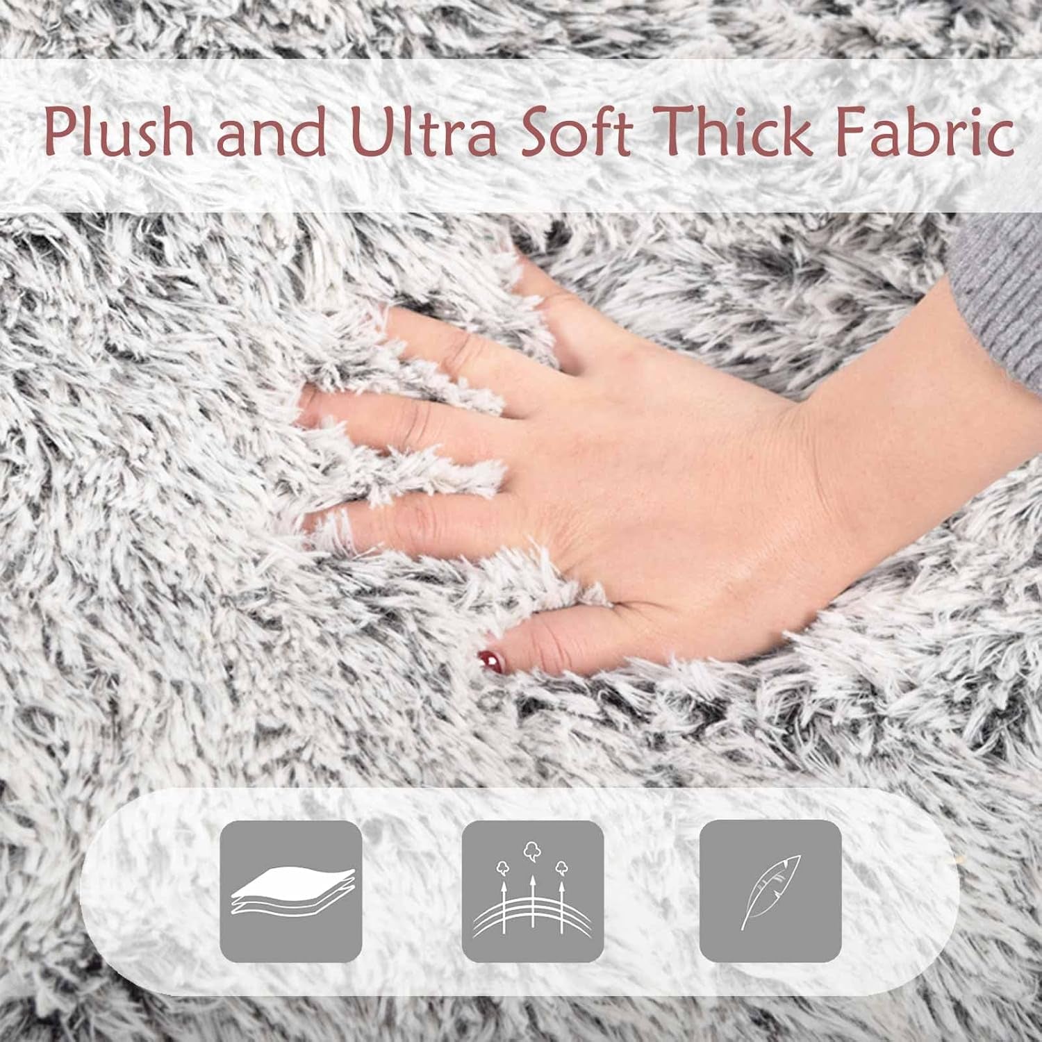 Close-up of a hand pressing into thick light-gray faux fur to show the plush, fluffy texture.