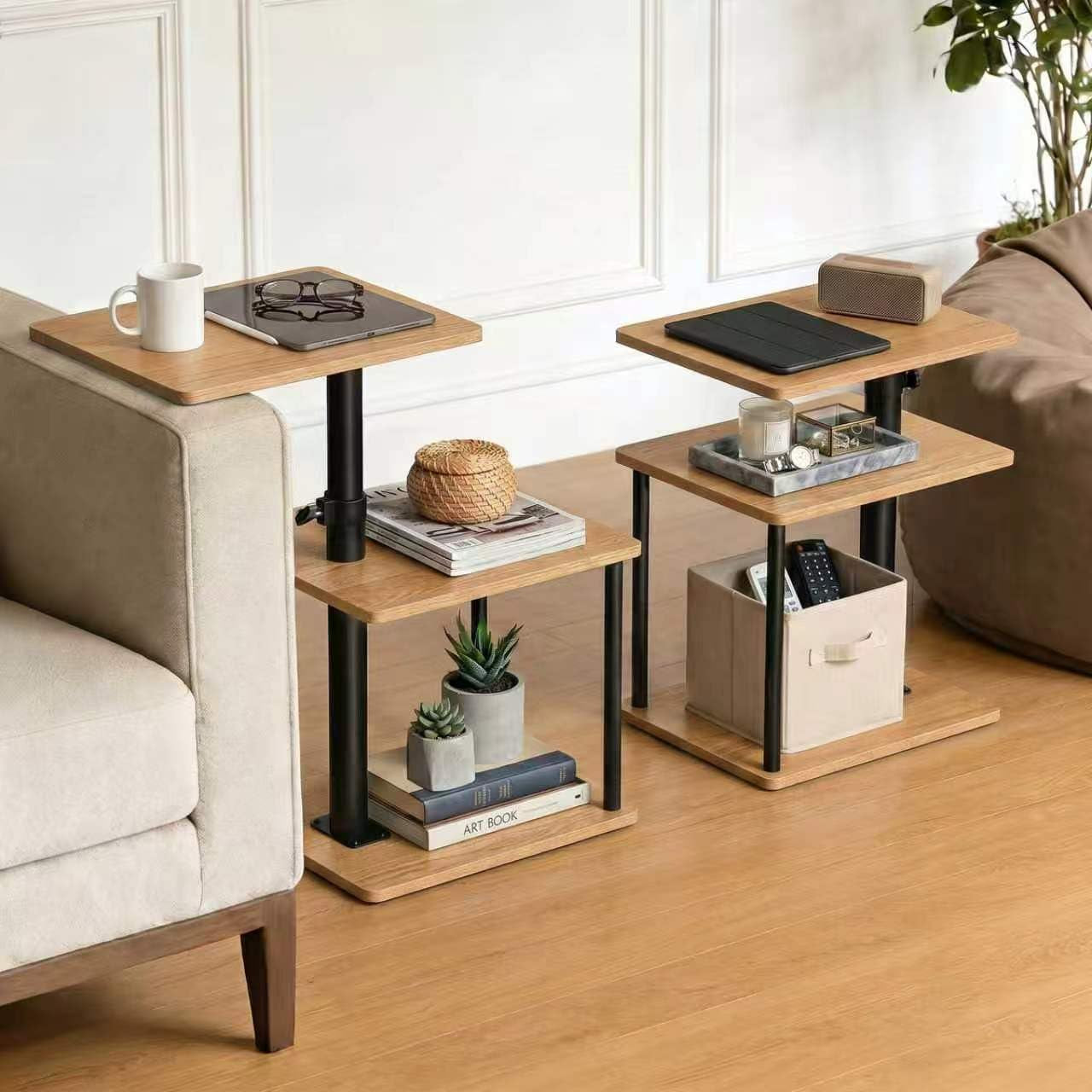 Two adjustable C‑shape side tables in light wood next to a sofa, showing different heights and shelf arrangements