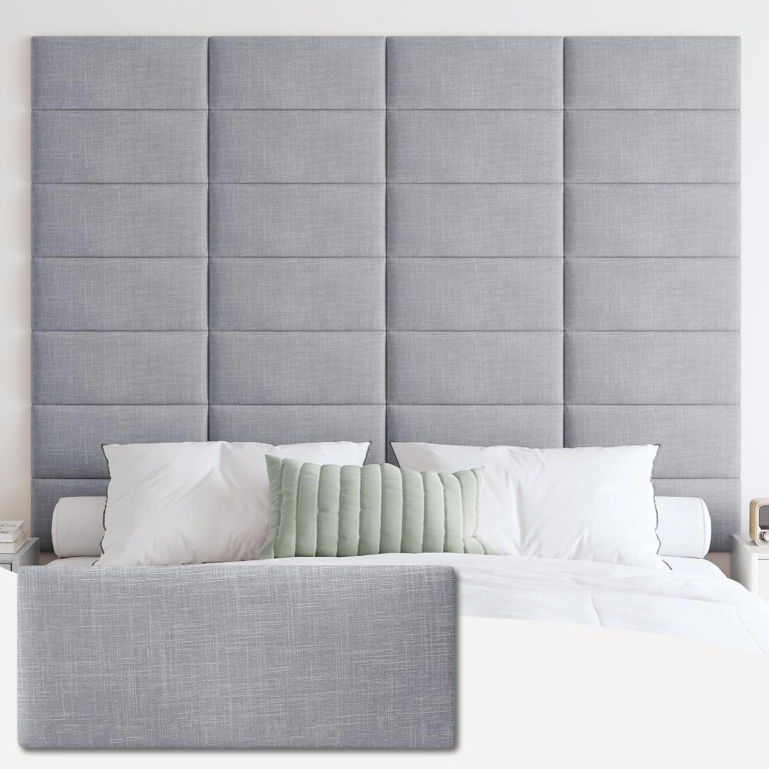Tall medium-gray tufted fabric headboard panels mounted above a bed with white pillows and a sage lumbar pillow.