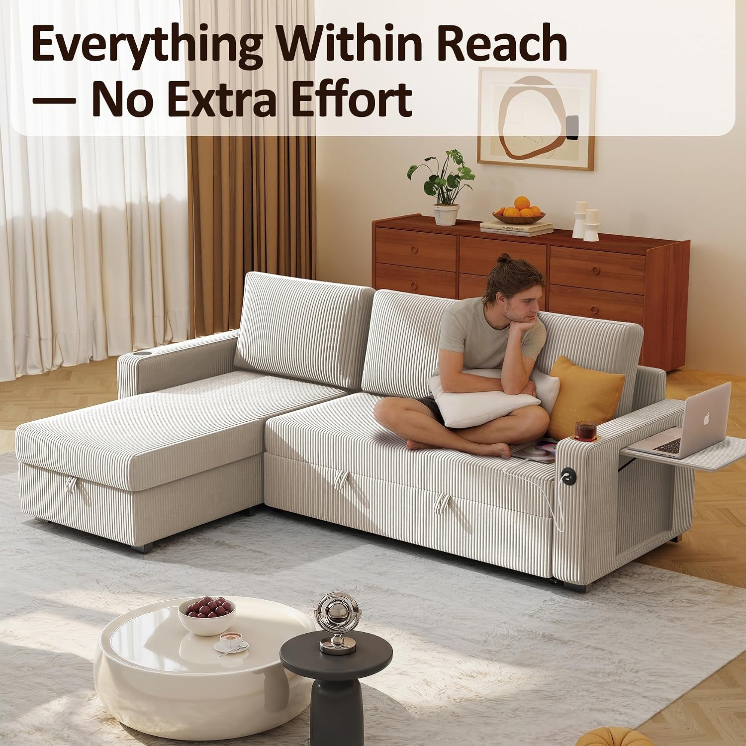 Living room with cream corduroy L-shaped sectional, man seated on sofa, chaise left, wooden dresser behind.