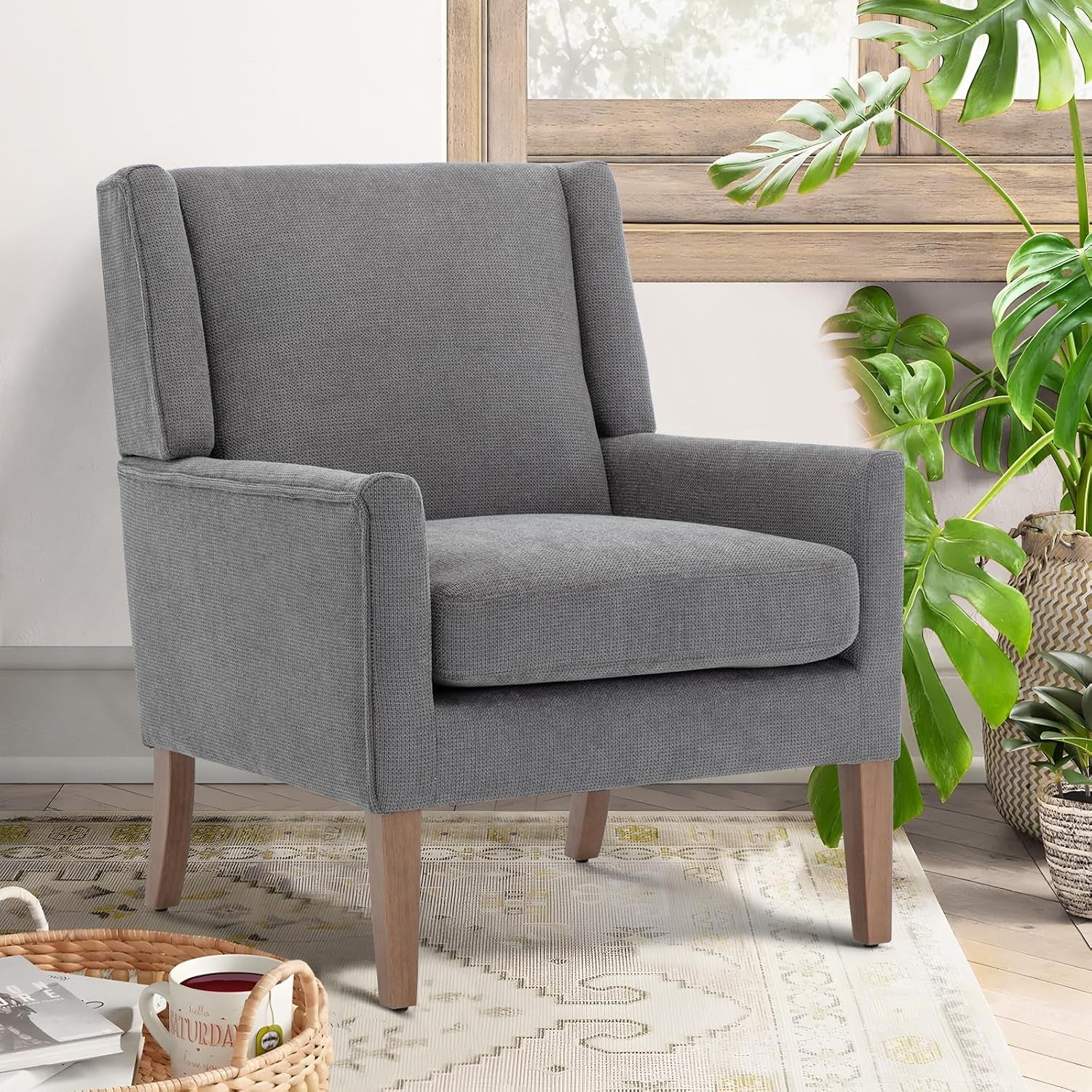 Single light gray chenille wingback chair shown near a window with houseplants and a woven rug