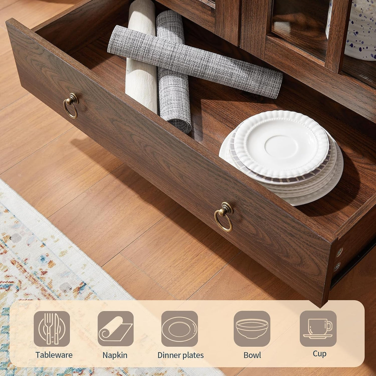 Close-up of the cabinet's open bottom drawer holding dishes and napkins