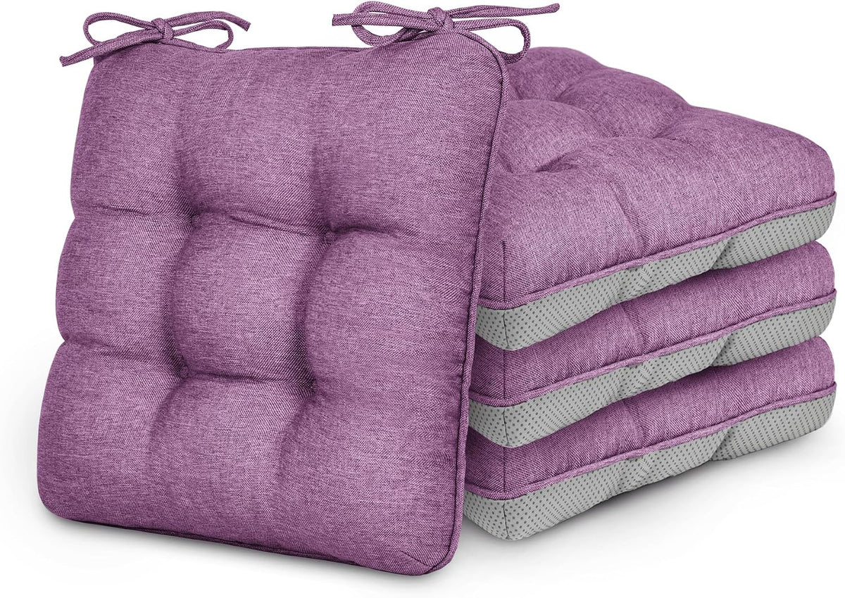 Stack of four tufted square chair cushions in purple with tied fabric bows on top corners