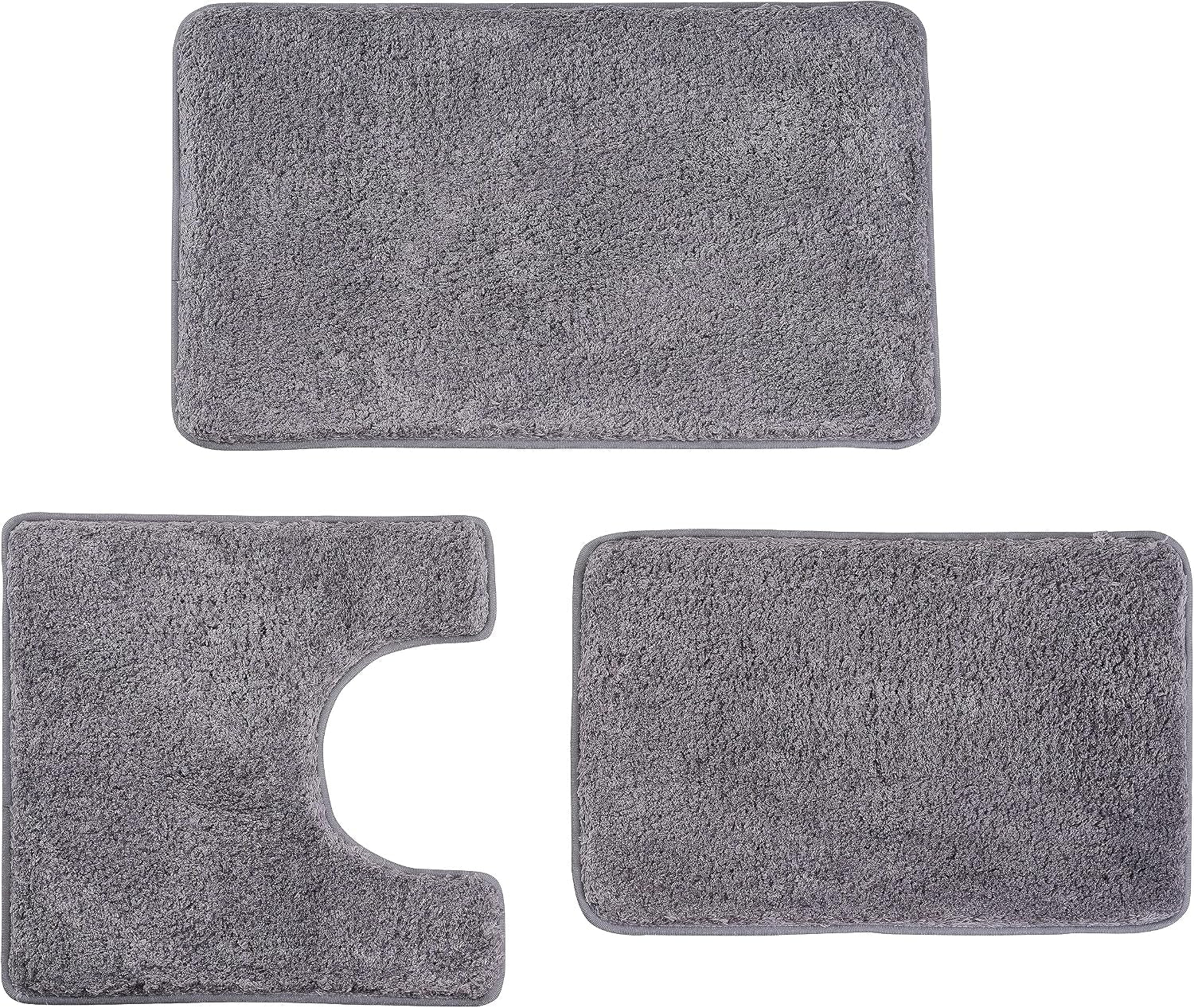 Flat lay of three dark gray plush bathroom mats: large rectangle, U-shaped toilet mat, and small rectangle.
