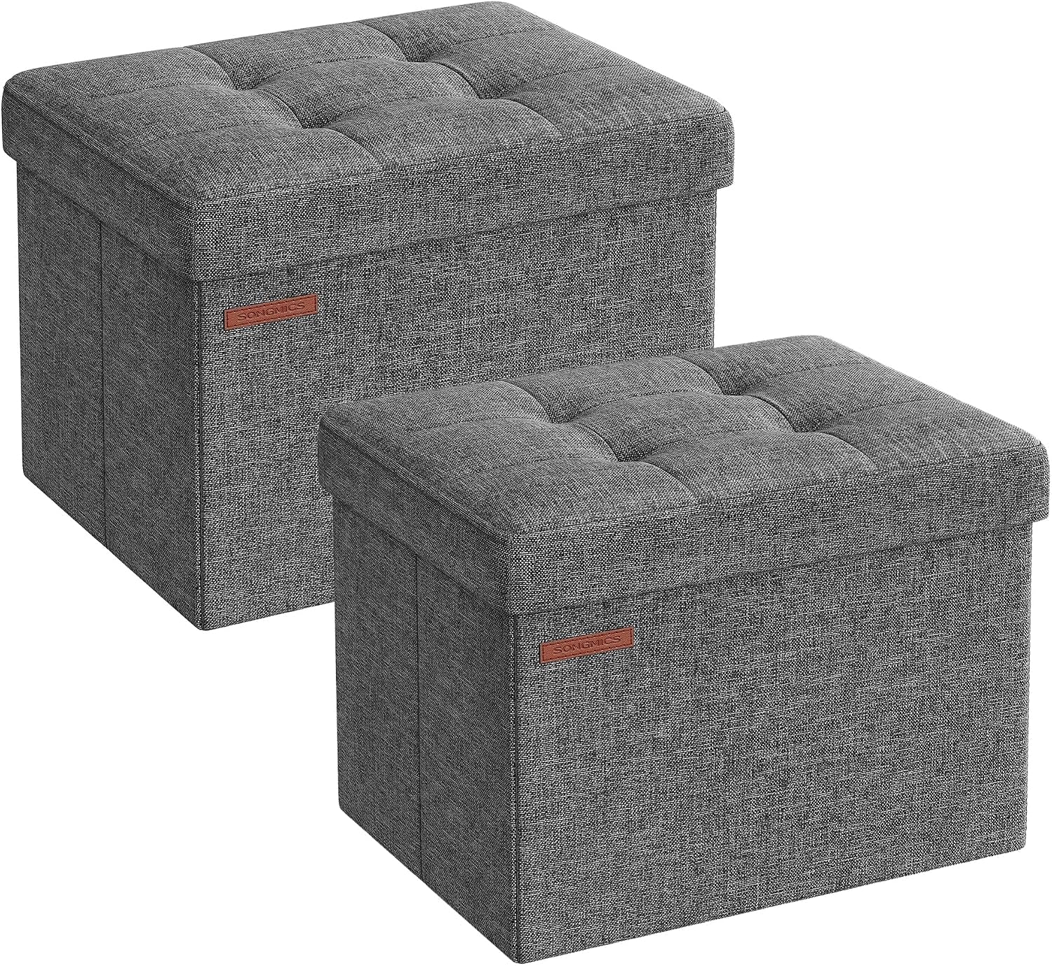 Two closed dark gray linen-look storage ottomans shown side by side
