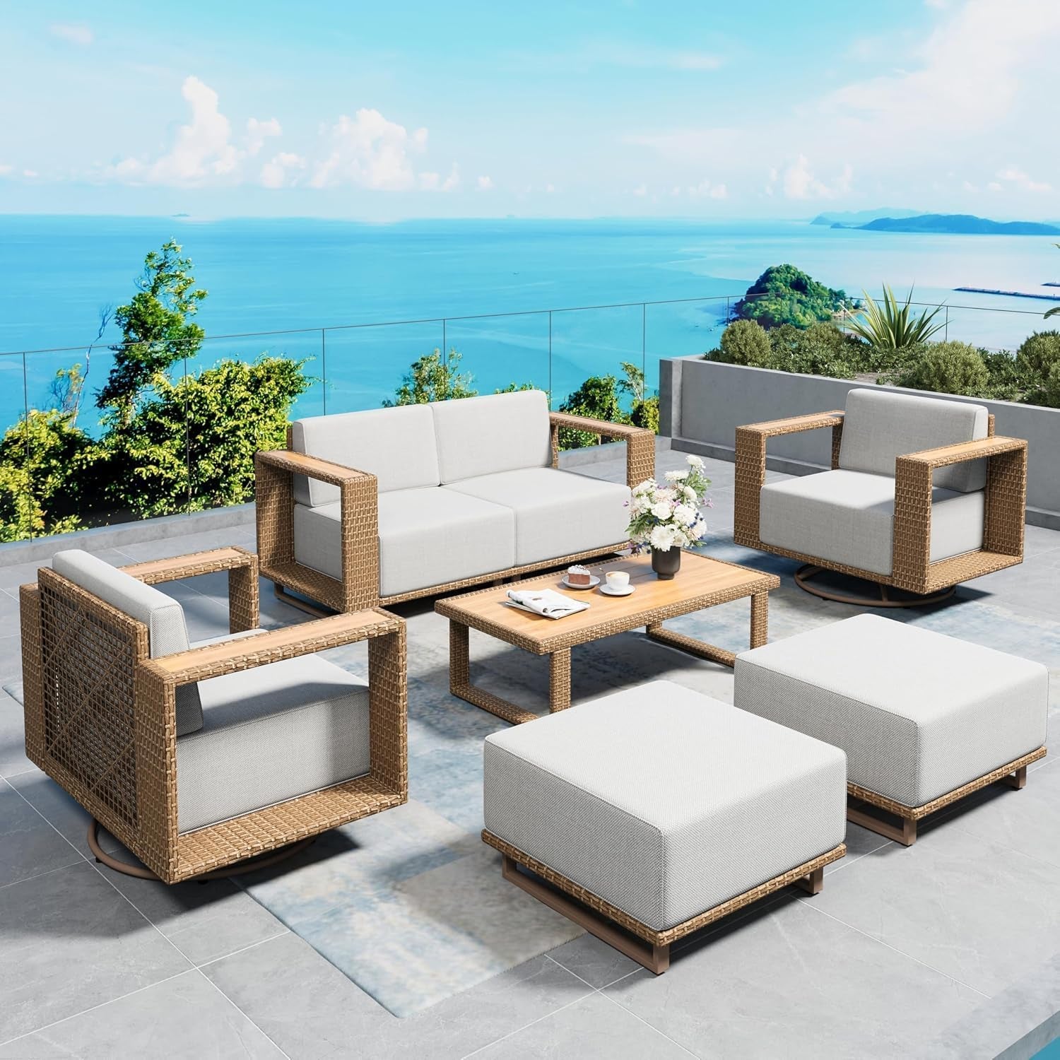 Angled shot of the seating set showing two ottomans, a low coffee table with flowers, and three armchairs on a tiled terrace.