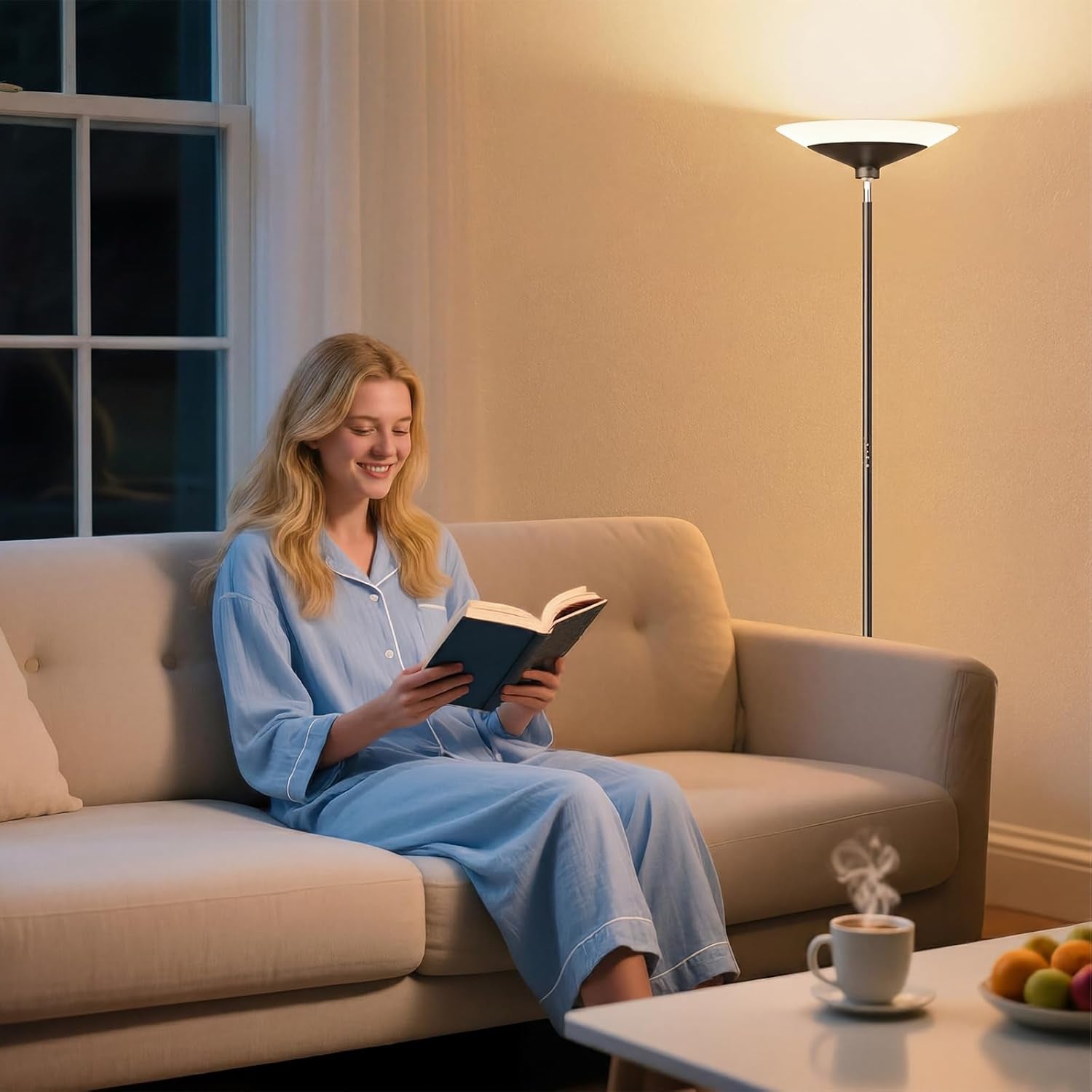 Woman reading on a sofa with a warm-lit torchiere floor lamp positioned behind and to the side