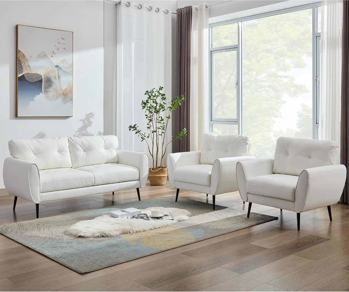 Wide-shot of white tufted loveseat and two matching chairs in a bright room from a slightly different angle