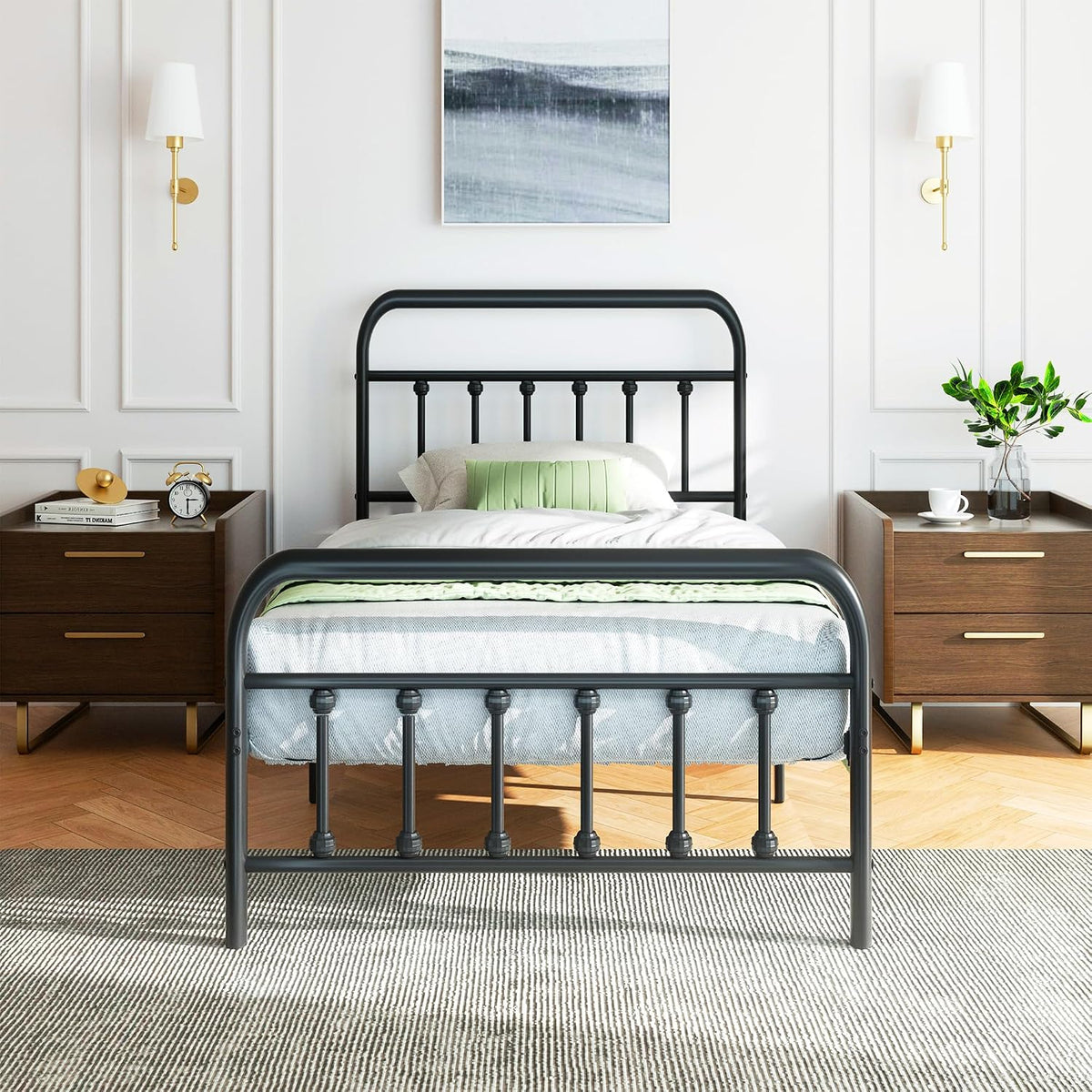 Black metal single bed frame shown head-on in a styled bedroom with two nightstands.