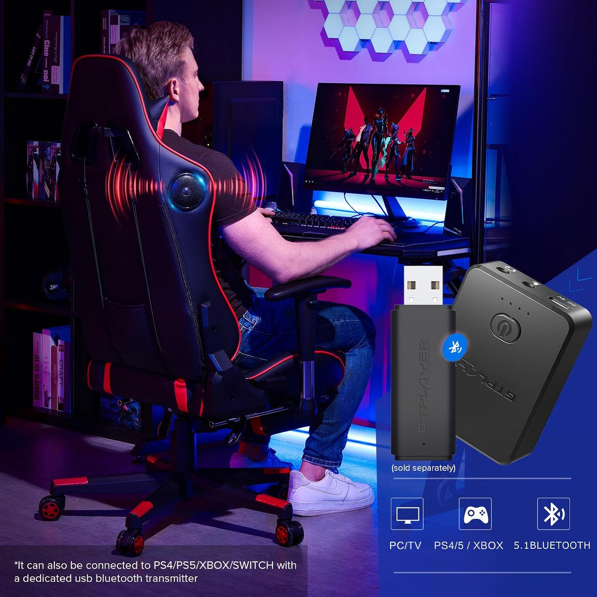 Person seated in a black-and-red gaming chair with rear speaker and LED-lit desk setup.