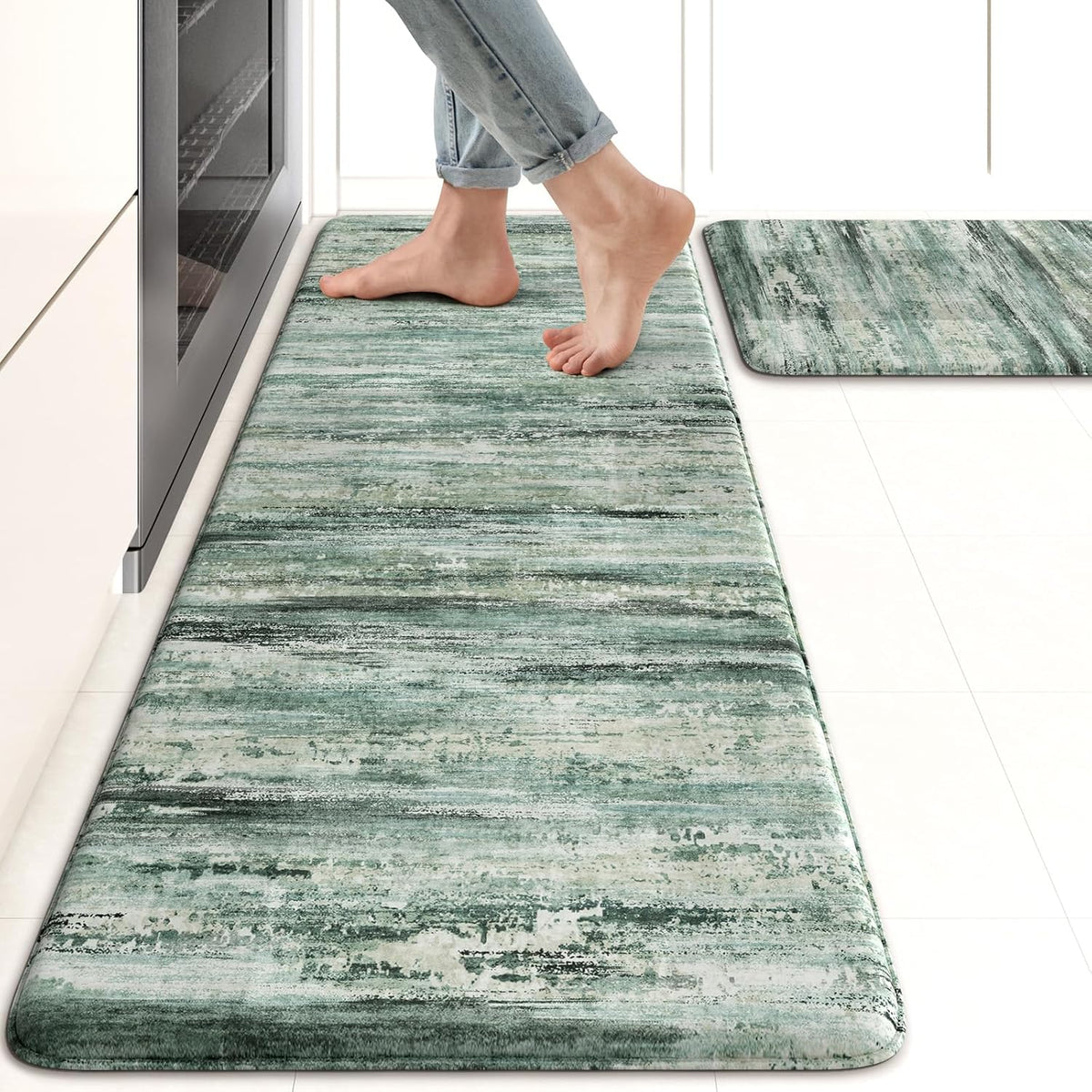 Close view of a green marbled runner and matching small mat with bare feet stepping on it.