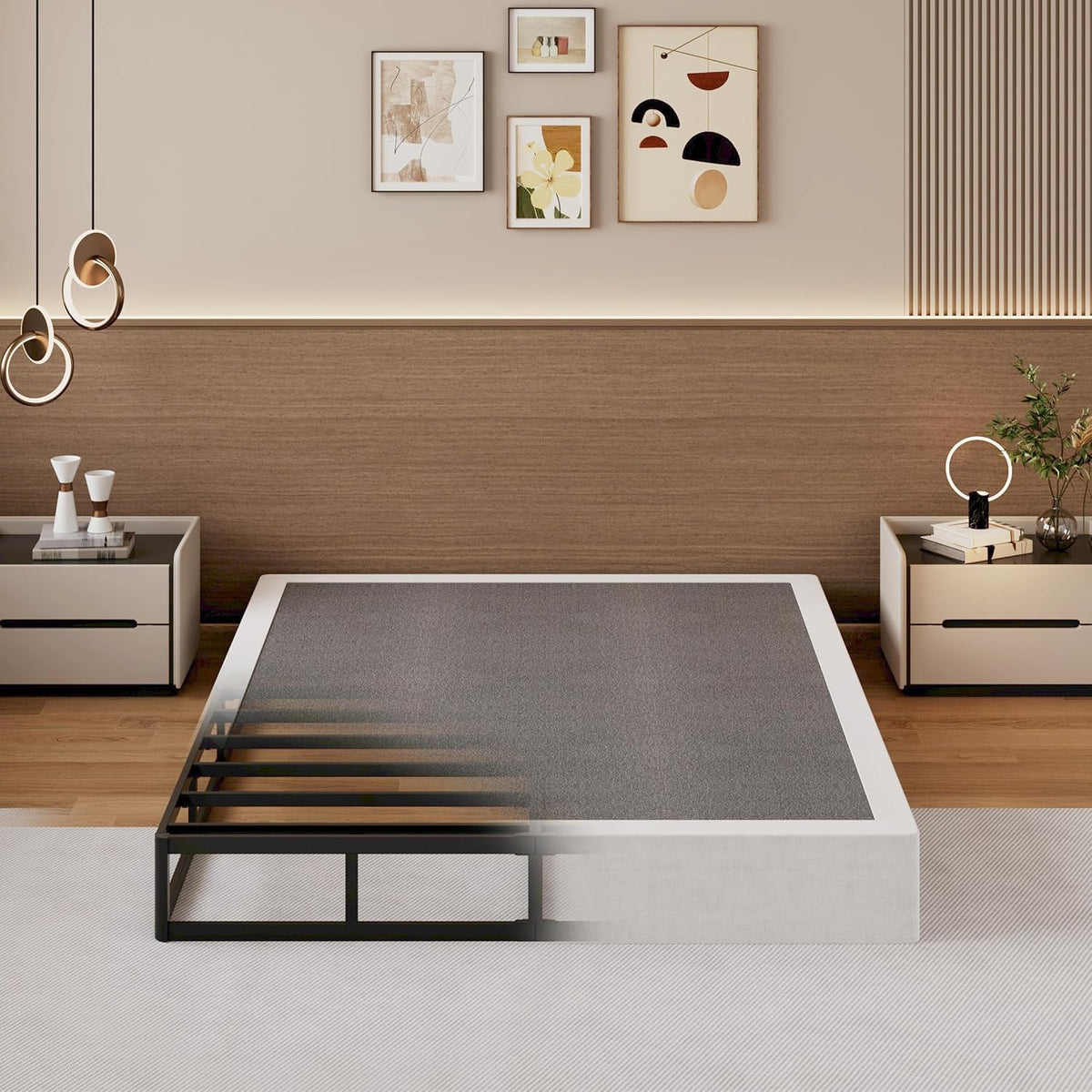 Half of the scene shows the black metal slatted frame, the other half an upholstered box spring to illustrate fit.
