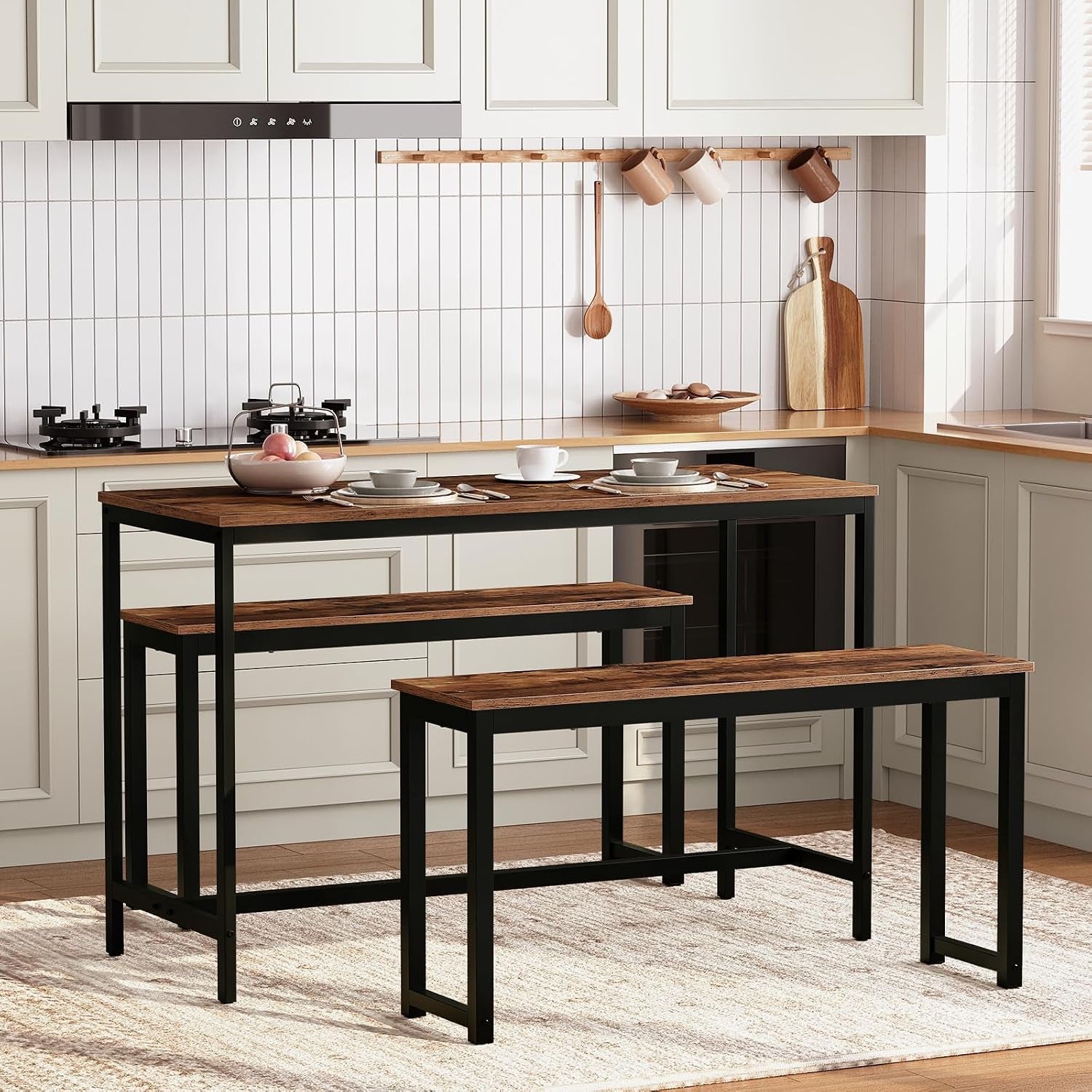 Kitchen scene with two rustic brown benches with black frames paired to a narrow dining table in a bright room