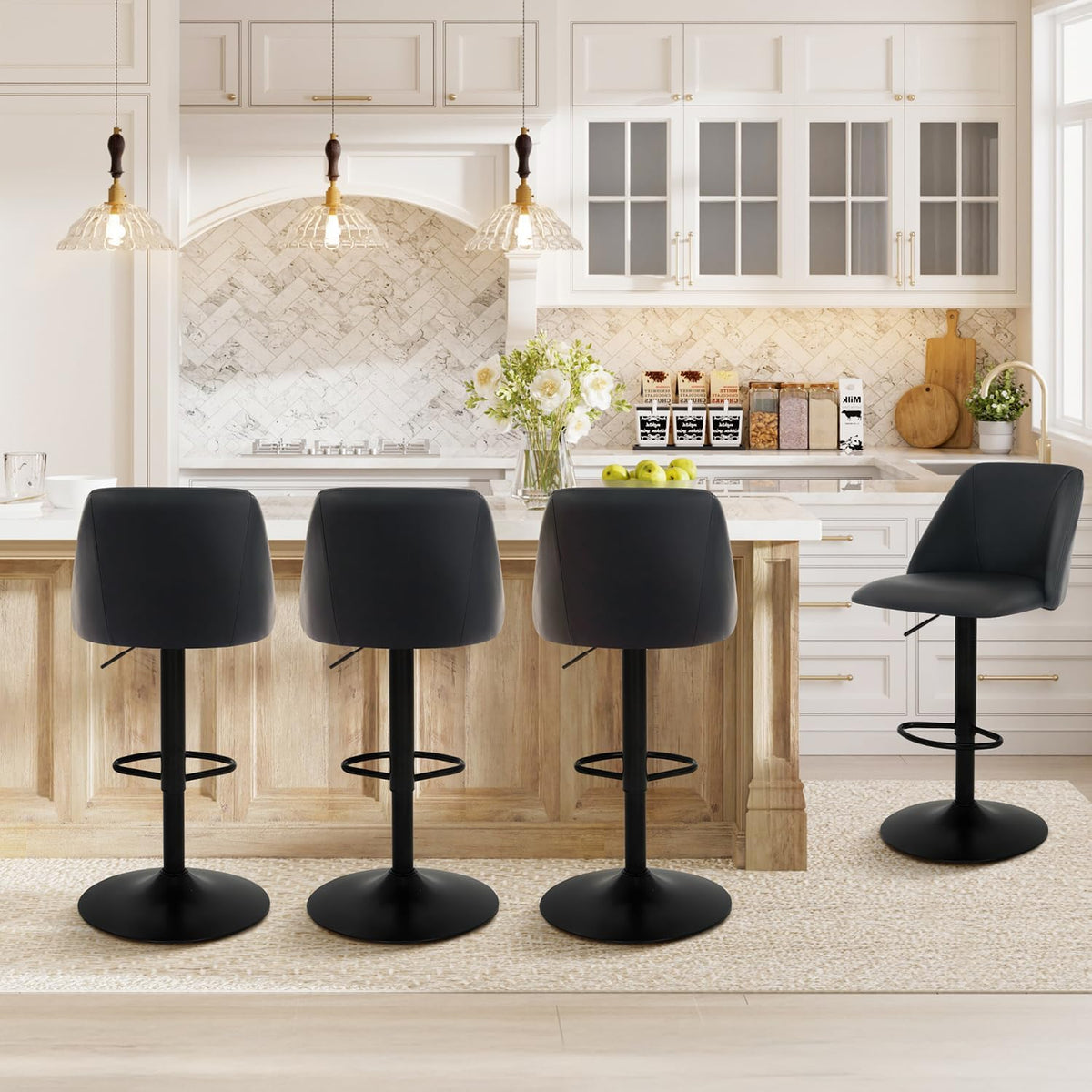 Rear view of three dark charcoal bar stools at the island and one stool angled to the right