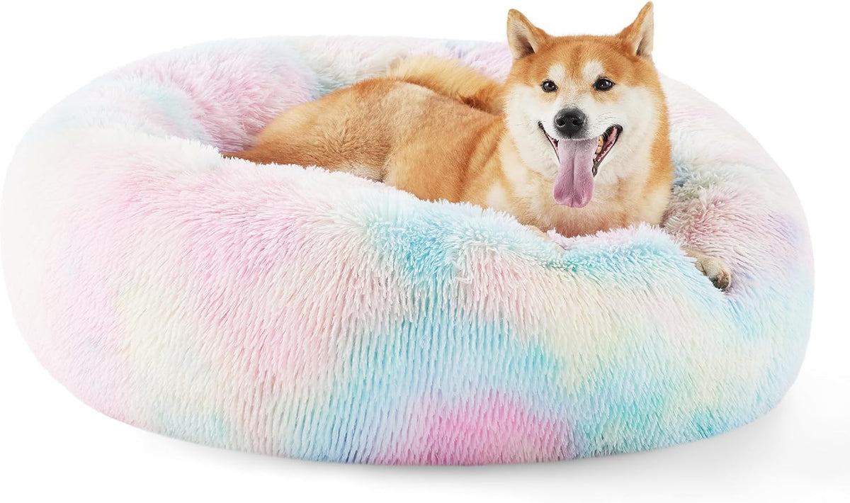 Pastel multicolor faux fur donut bed with a smiling tan dog lying inside