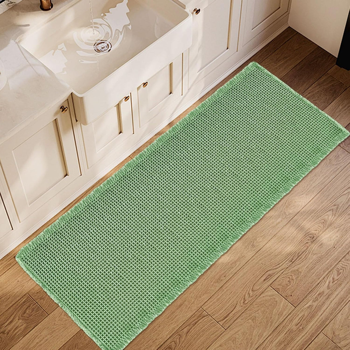 Long mint-green waffle runner laid on a wood bathroom floor next to a sink cabinet