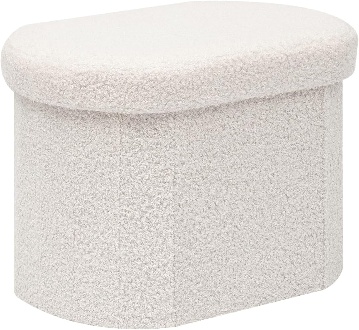 Small cream sherpa-covered storage ottoman with rounded top, front and right sides visible
