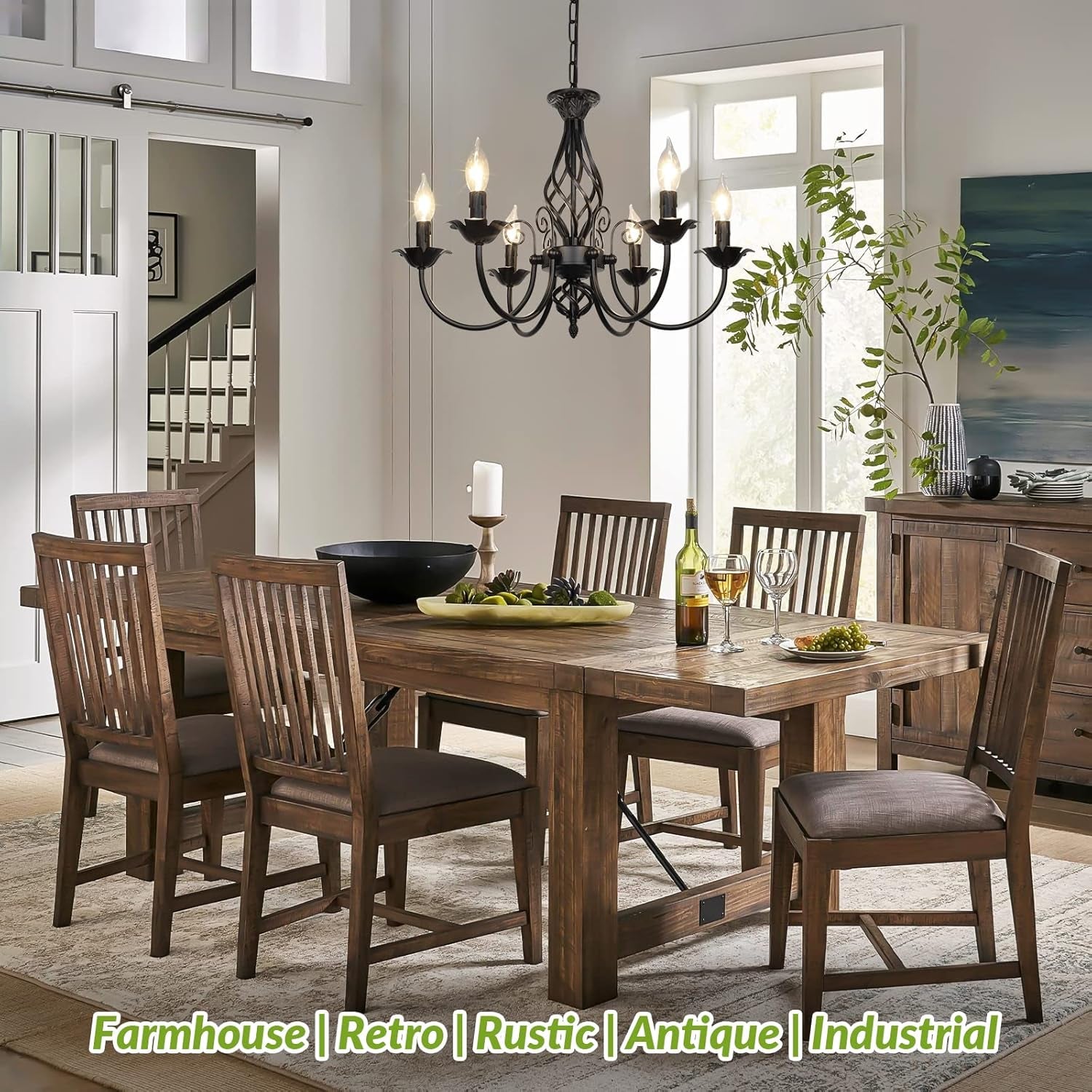 Black chandelier hanging over a wooden dining table in a bright dining room setting showing scale and placement