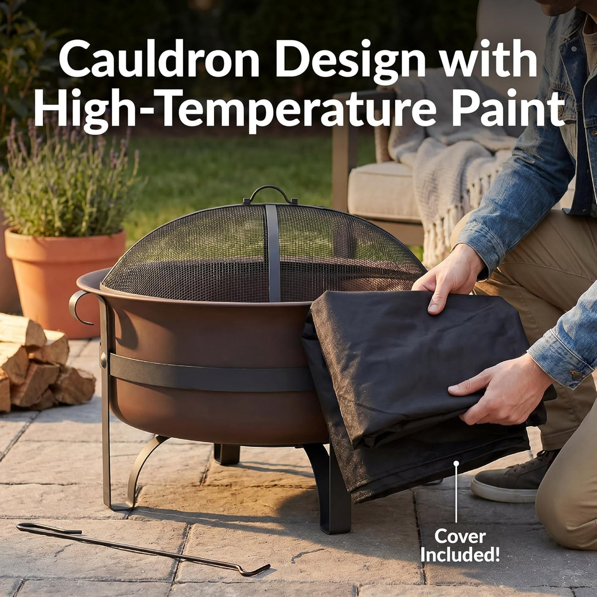 Dark bronze cauldron-style fire pit with folded protective cover beside it and a fire poker on the patio