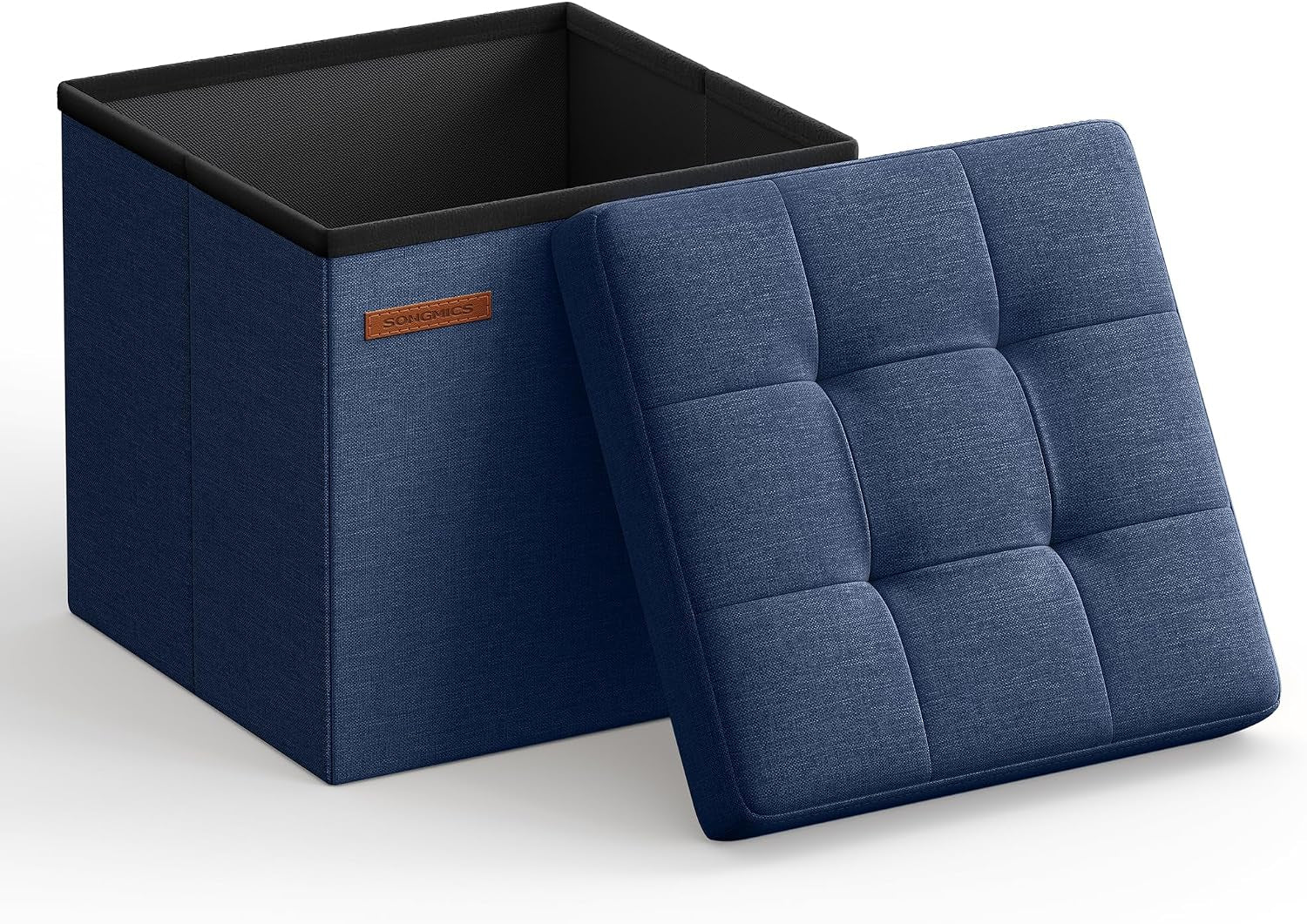 Open navy fabric storage cube with its tufted lid leaning against the side