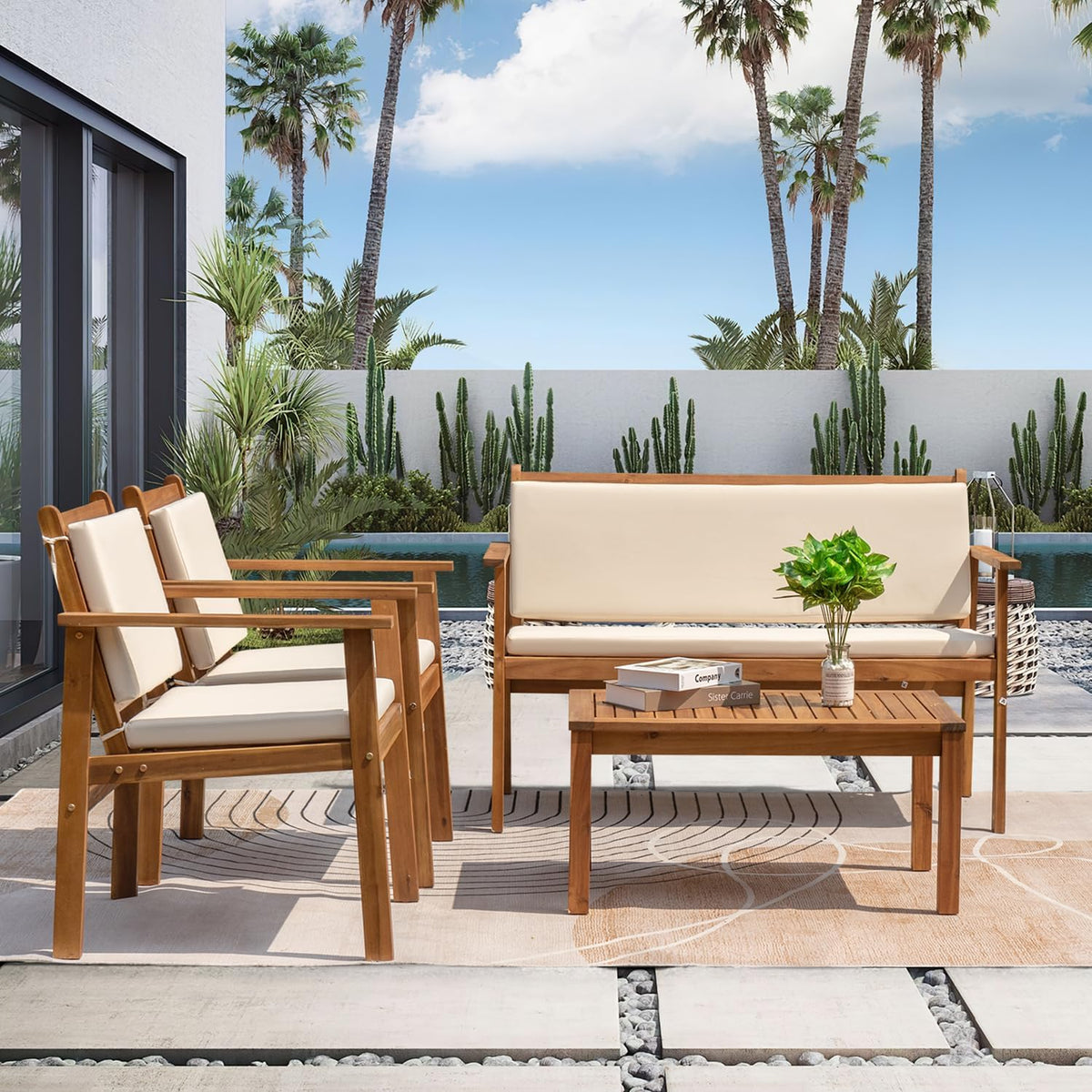 Acacia wood loveseat and two armchairs with white cushions staged beside a pool, front view