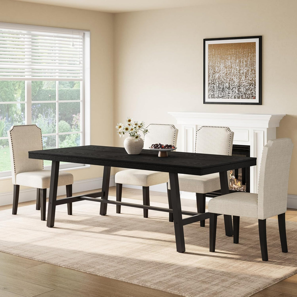Black rectangular dining table with matching dark legs set with four beige upholstered chairs in a dining room.