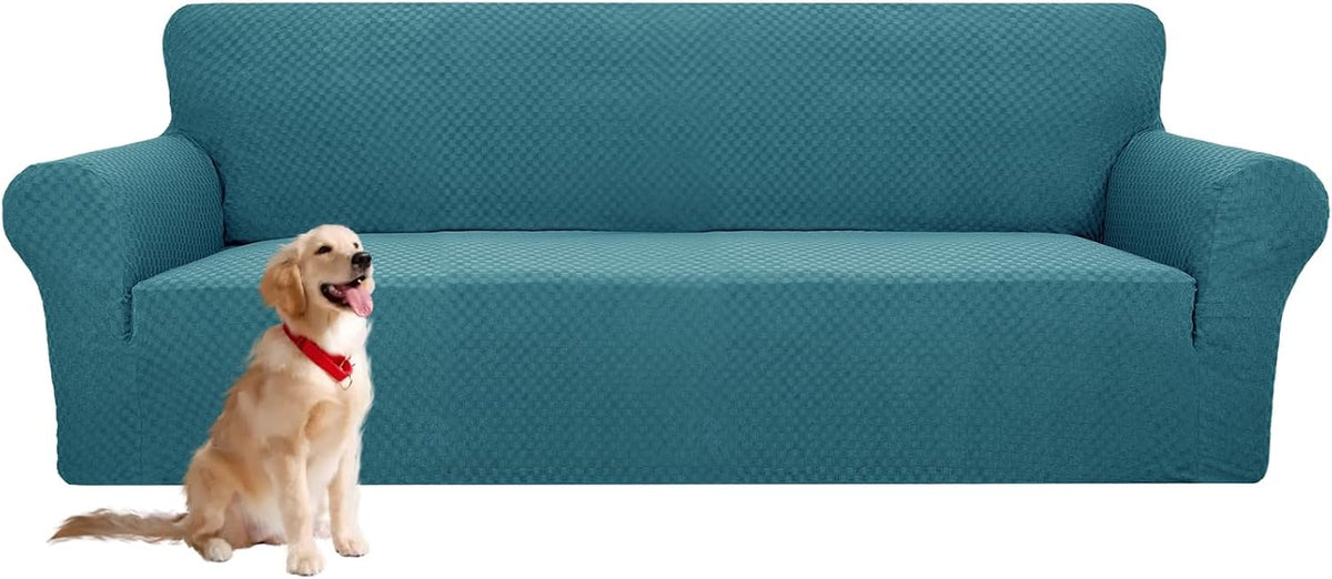 Front view of a teal textured sofa cover on a three-cushion couch with a golden retriever seated in front