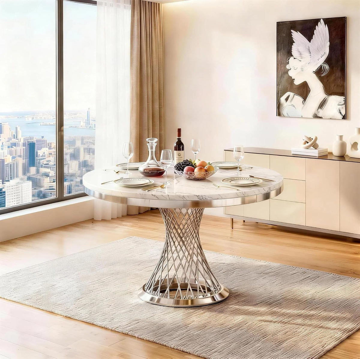 Angled room shot of the round faux‑marble table with a twisted lattice stainless steel cage base and fruit bowl on top.