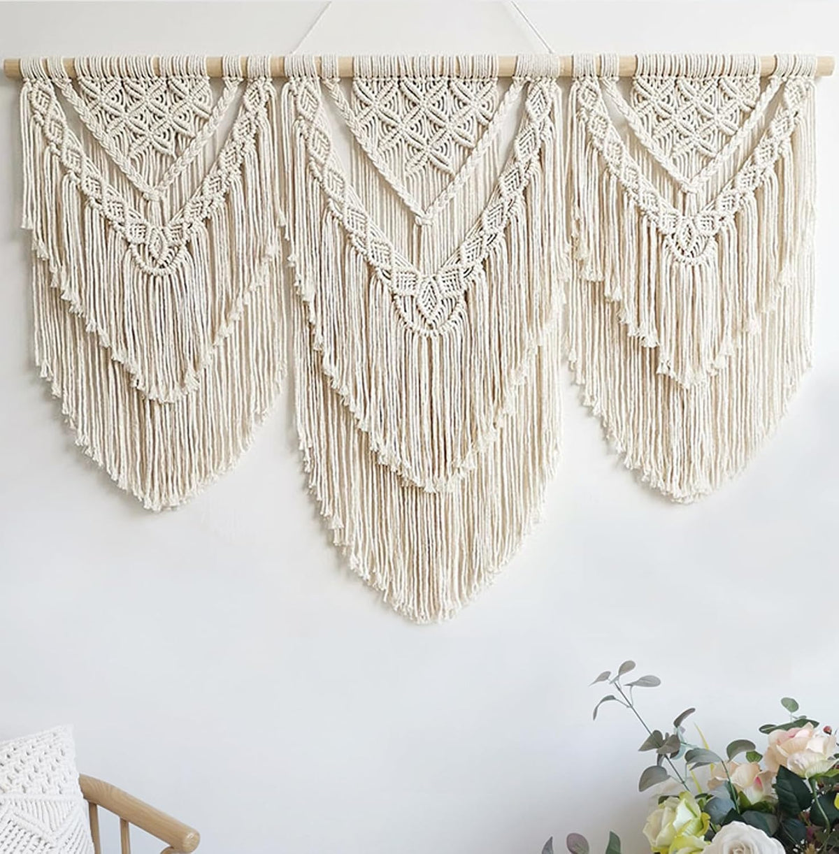 Evenly lit straight-on view of the macrame showing layered scalloped fringe across all three panels.