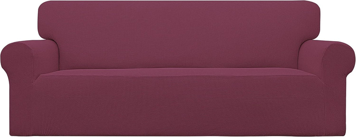 Front view of a loveseat dressed in a textured burgundy stretch slipcover wrapping the arms and seat