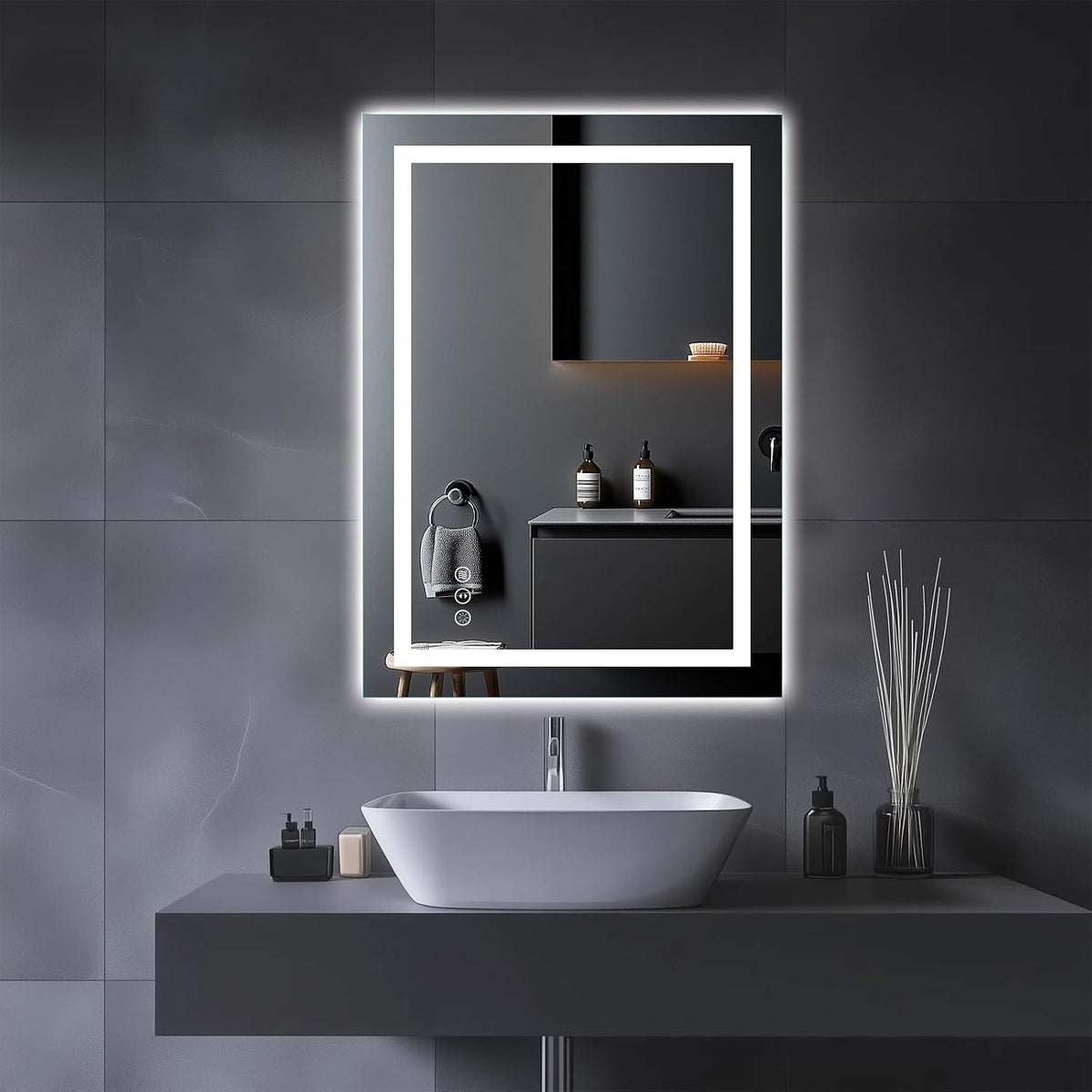 Tall vertical LED mirror with double light frame mounted above a vessel sink on a dark tiled wall