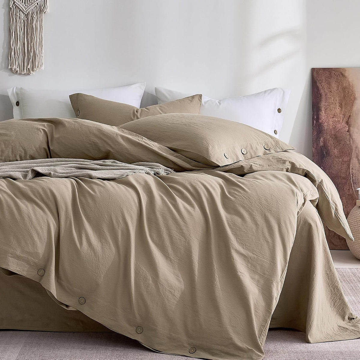 Neutral beige duvet and pillows arranged on a bed, showing wooden button closures at the hem.