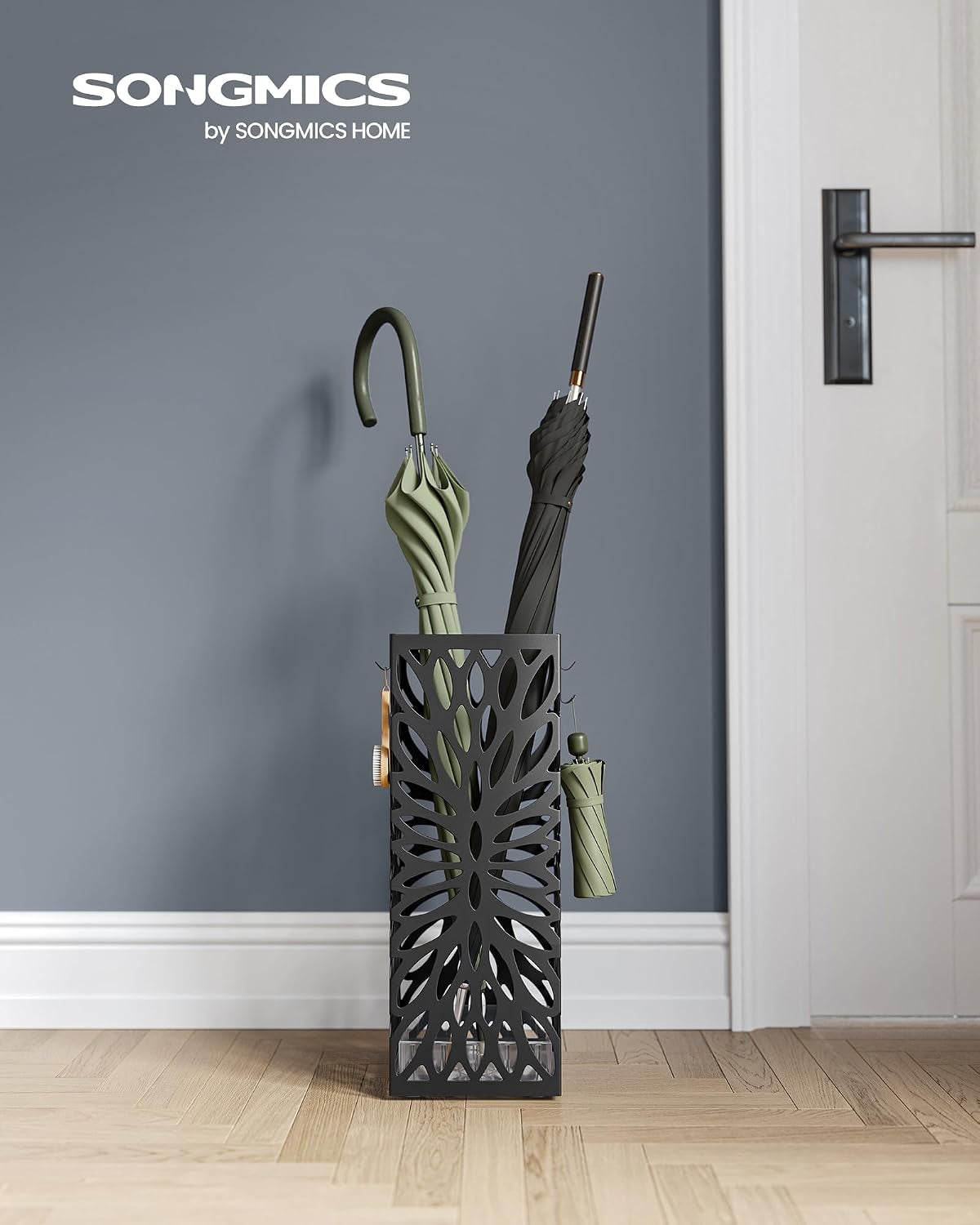 Black square umbrella stand placed in an entryway against a blue-gray wall with two umbrellas inside