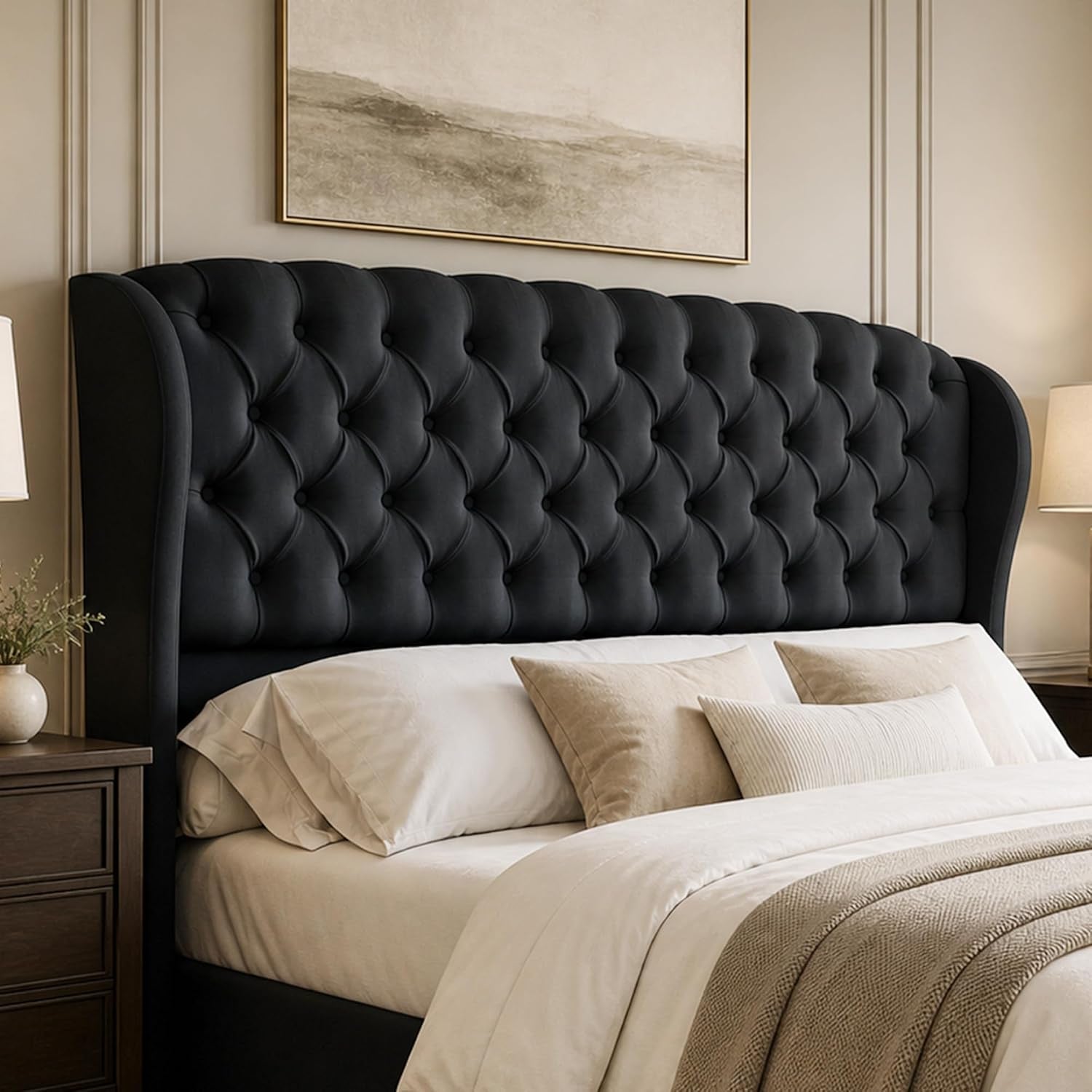 Close angled view of a dark charcoal tufted wingback headboard above a made bed.