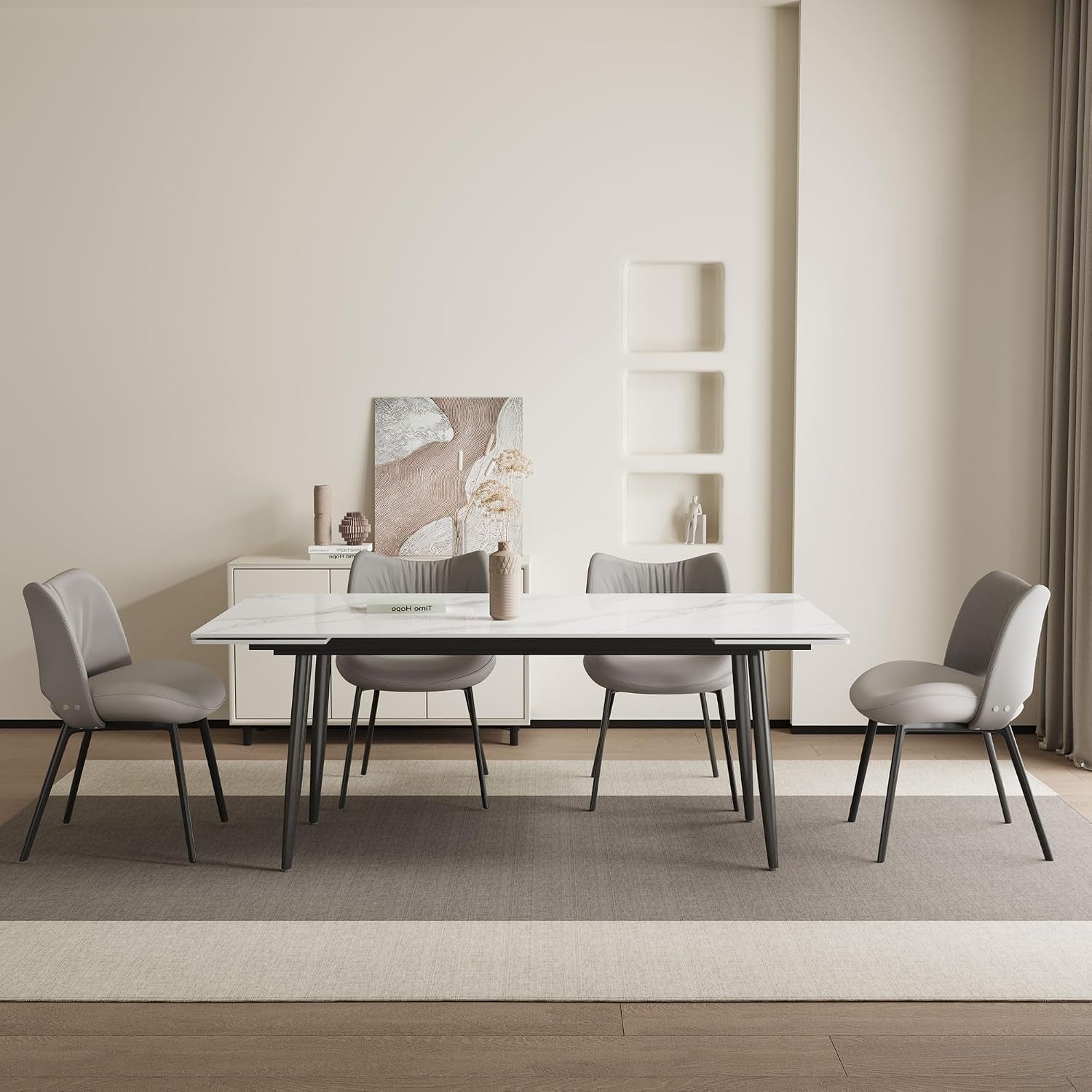 Straight-on view of the table in closed configuration with chairs and minimalist wall decor