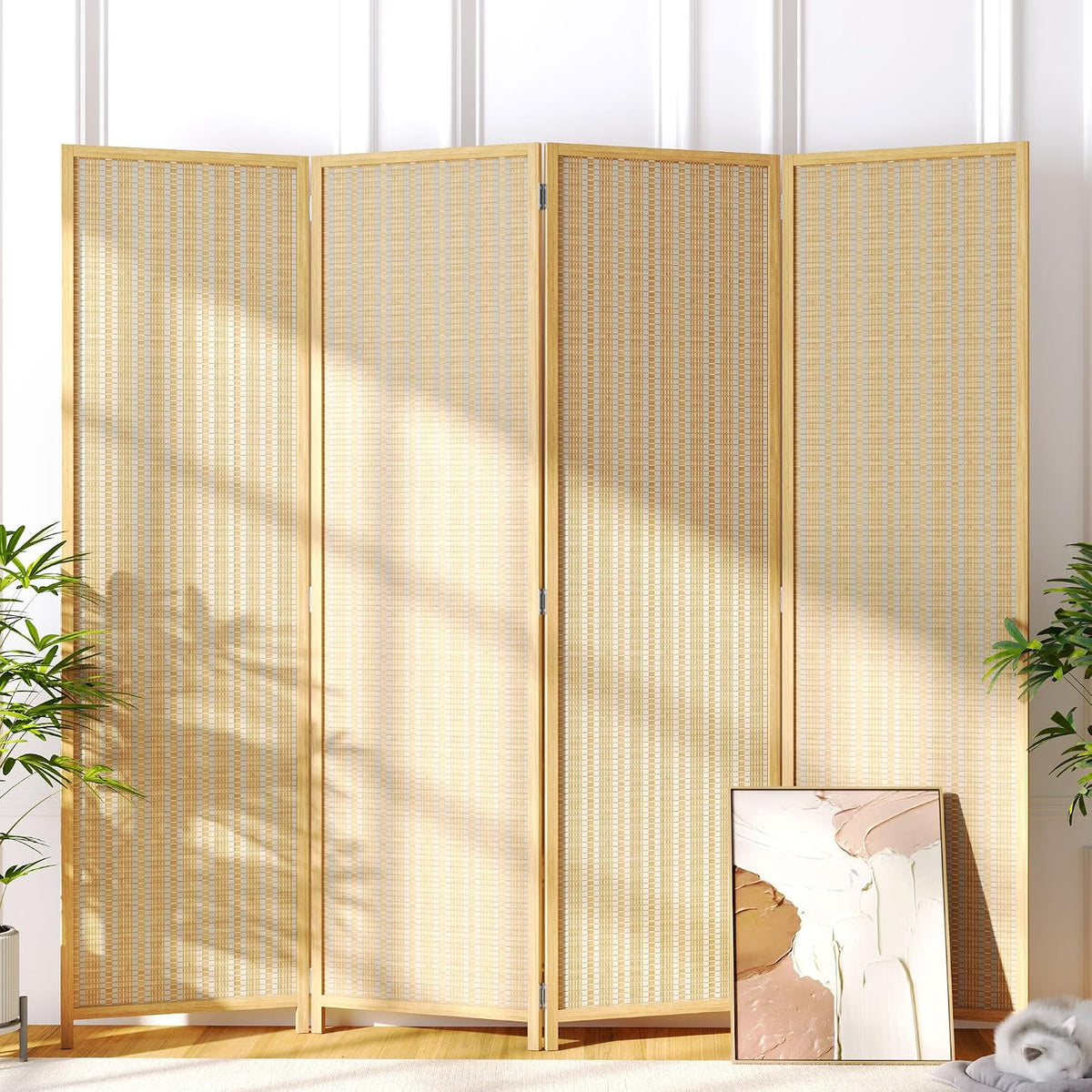 Four-panel beige bamboo room divider freestanding front view in a sunlit living room with plants and leaning artwork