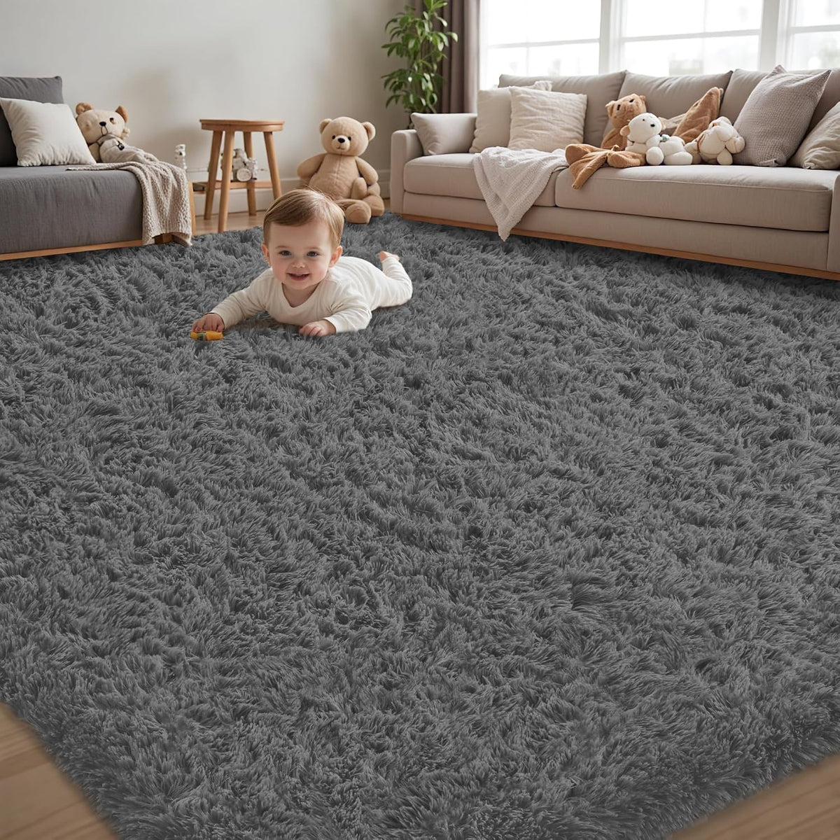 Low-angle foreground view of thick charcoal-gray shag rug with a baby and plush toys by beige sofas.