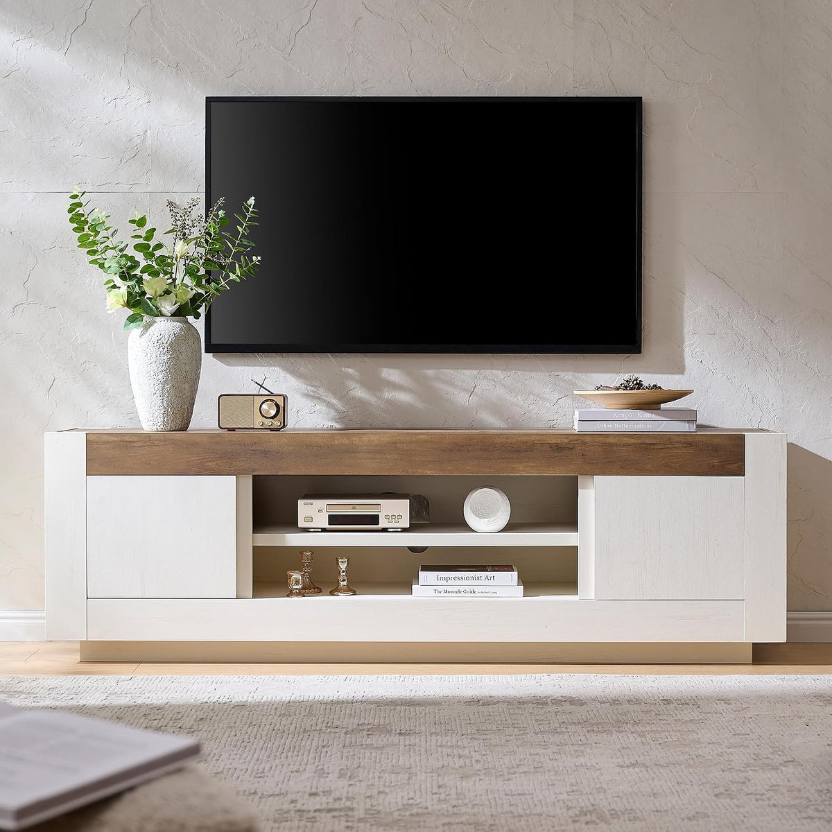 Antique white TV stand with wood-grain top beneath a wall-mounted TV