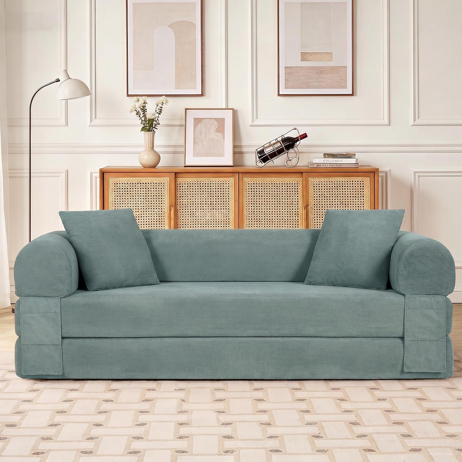 Front-facing light green corduroy sofa with two square pillows in a styled living room
