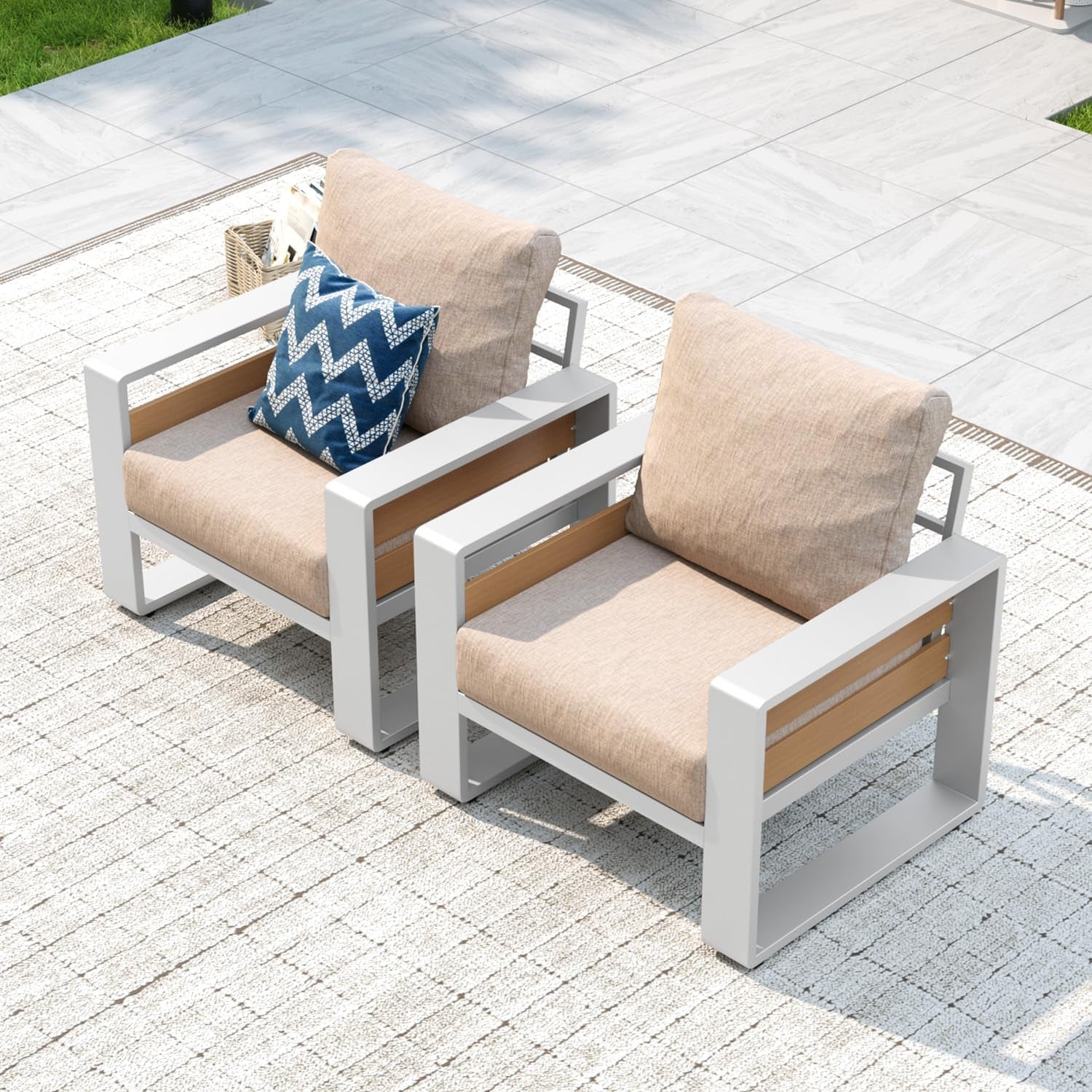 Top-down view of two beige-cushioned outdoor armchairs with white metal frames and wood slats.