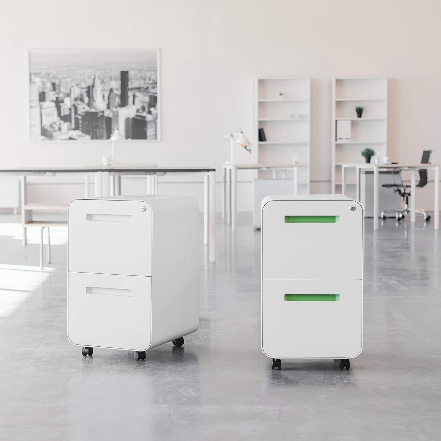 Two white mobile file cabinets with inset handles shown in a bright open office setting