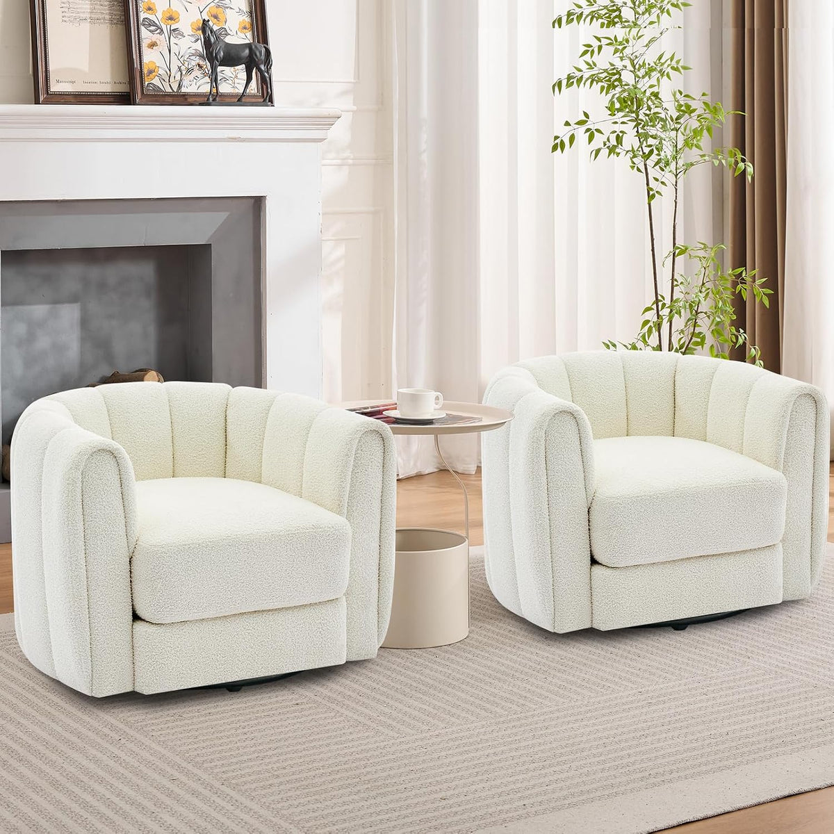 Pair of off-white teddy-fleece swivel barrel chairs flanking a small round side table in a living room.