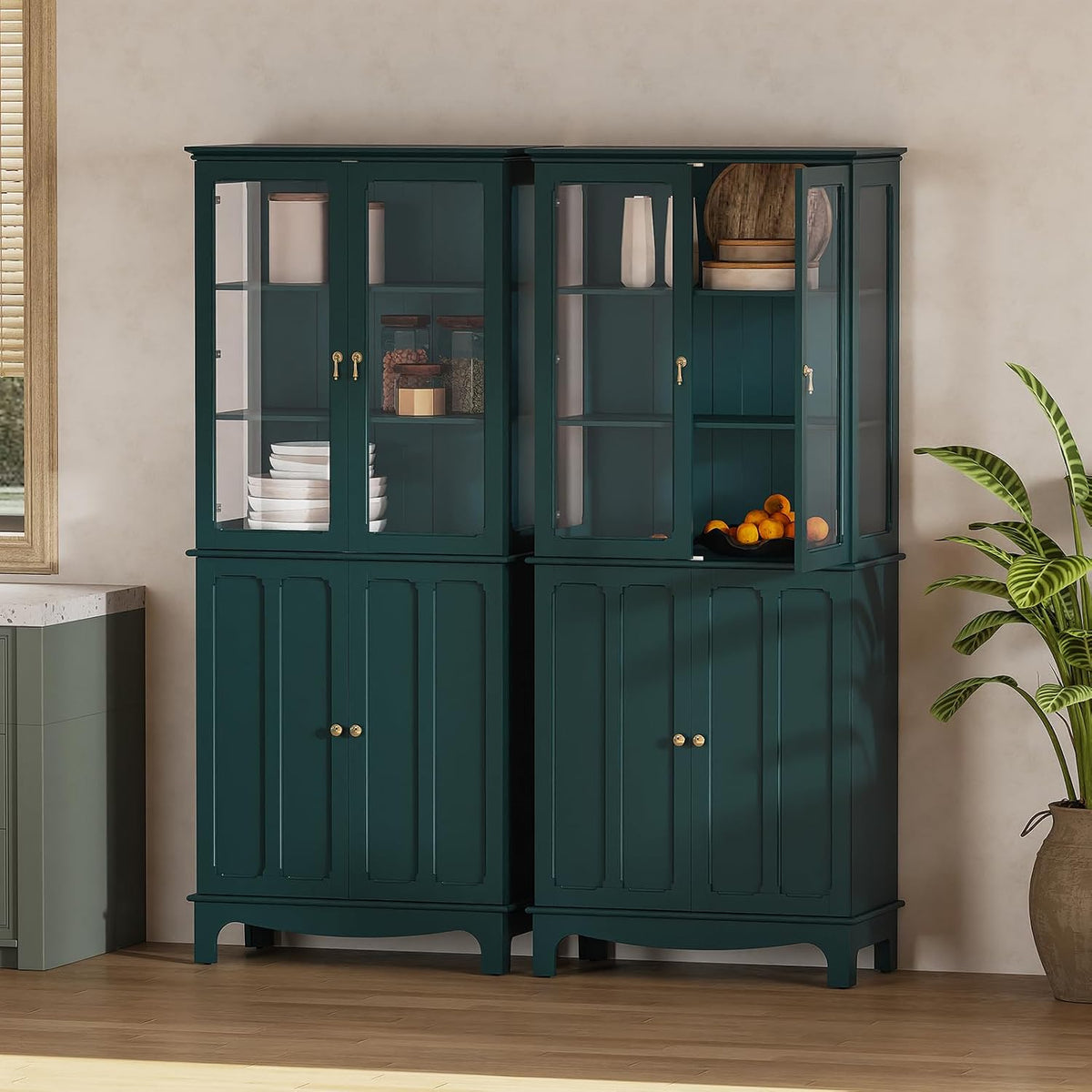 Two dark teal cabinets side-by-side with glass upper doors staged against a neutral wall